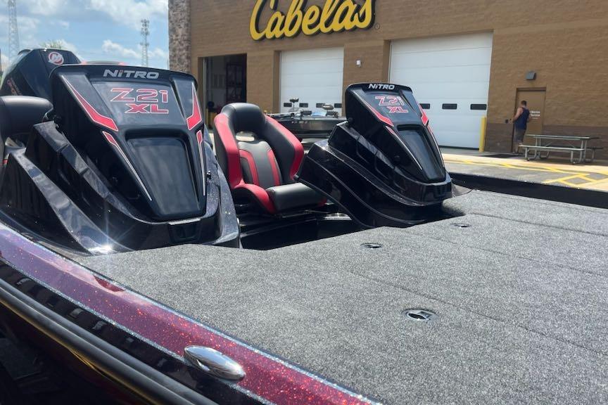 2026 Nitro Z21 XL Pro boat at Cabela's store, featuring sleek design and red accents.