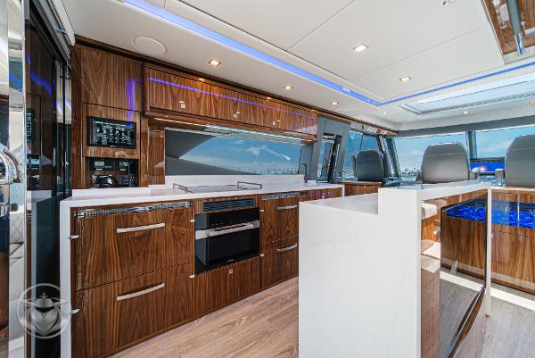 Luxurious interior of 2025 Riviera 645 SUV yacht with modern kitchen and sleek design.