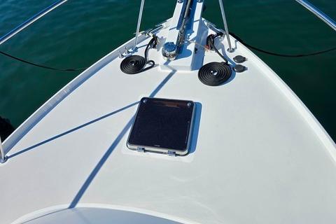 2006 Lyman-Morse 38 Jet Boat bow with hatch and railing on calm water.