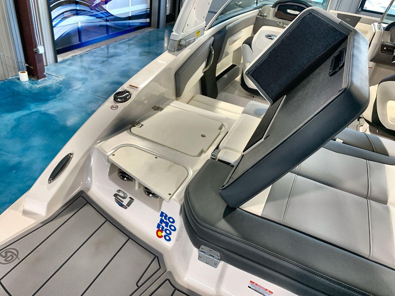 2025 Chaparral 21 SSi boat interior with open storage compartment and sleek seating design.
