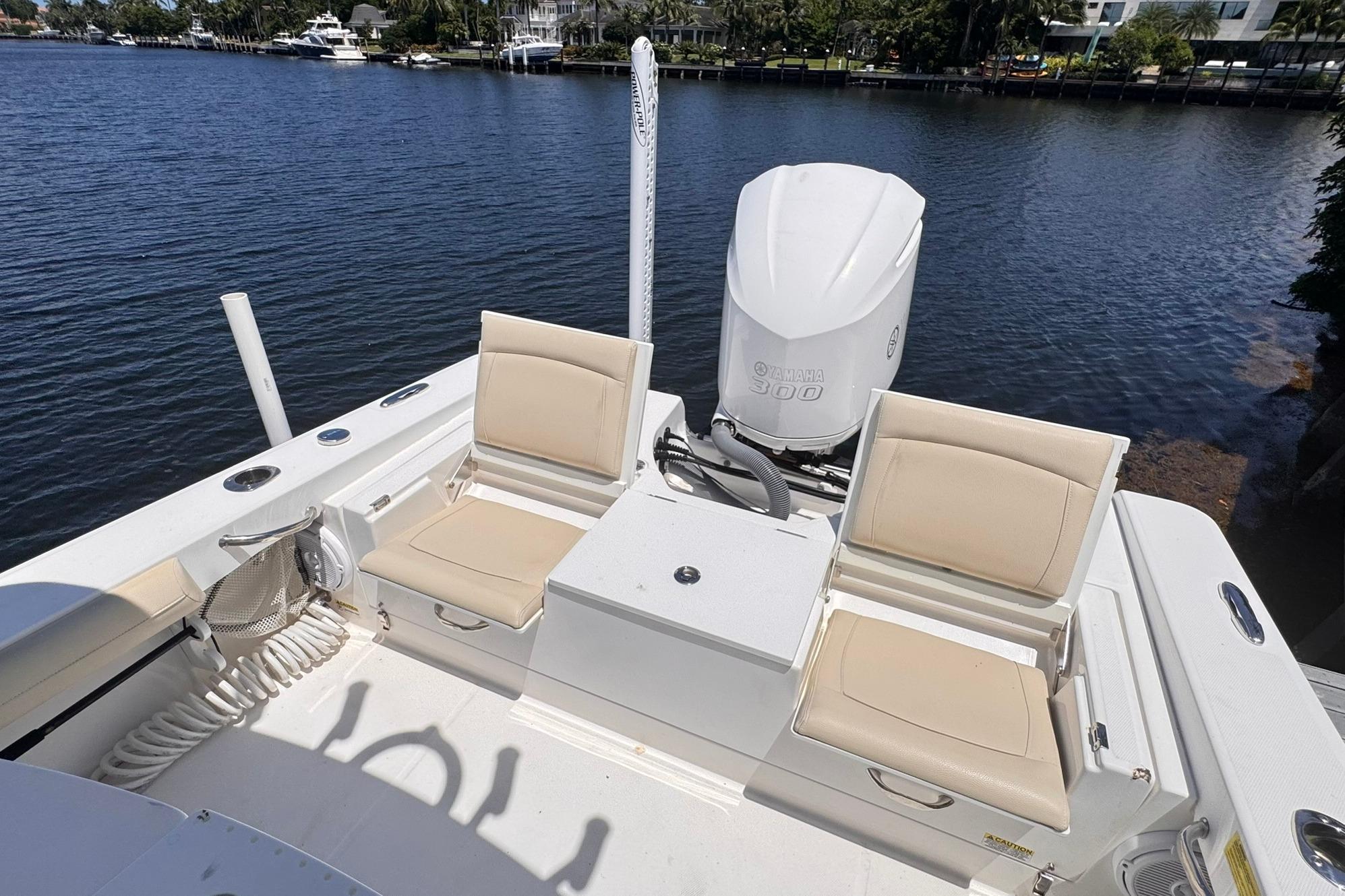 2018 Everglades 253 Center Console boat with Yamaha 300 engine, docked by a serene waterfront.