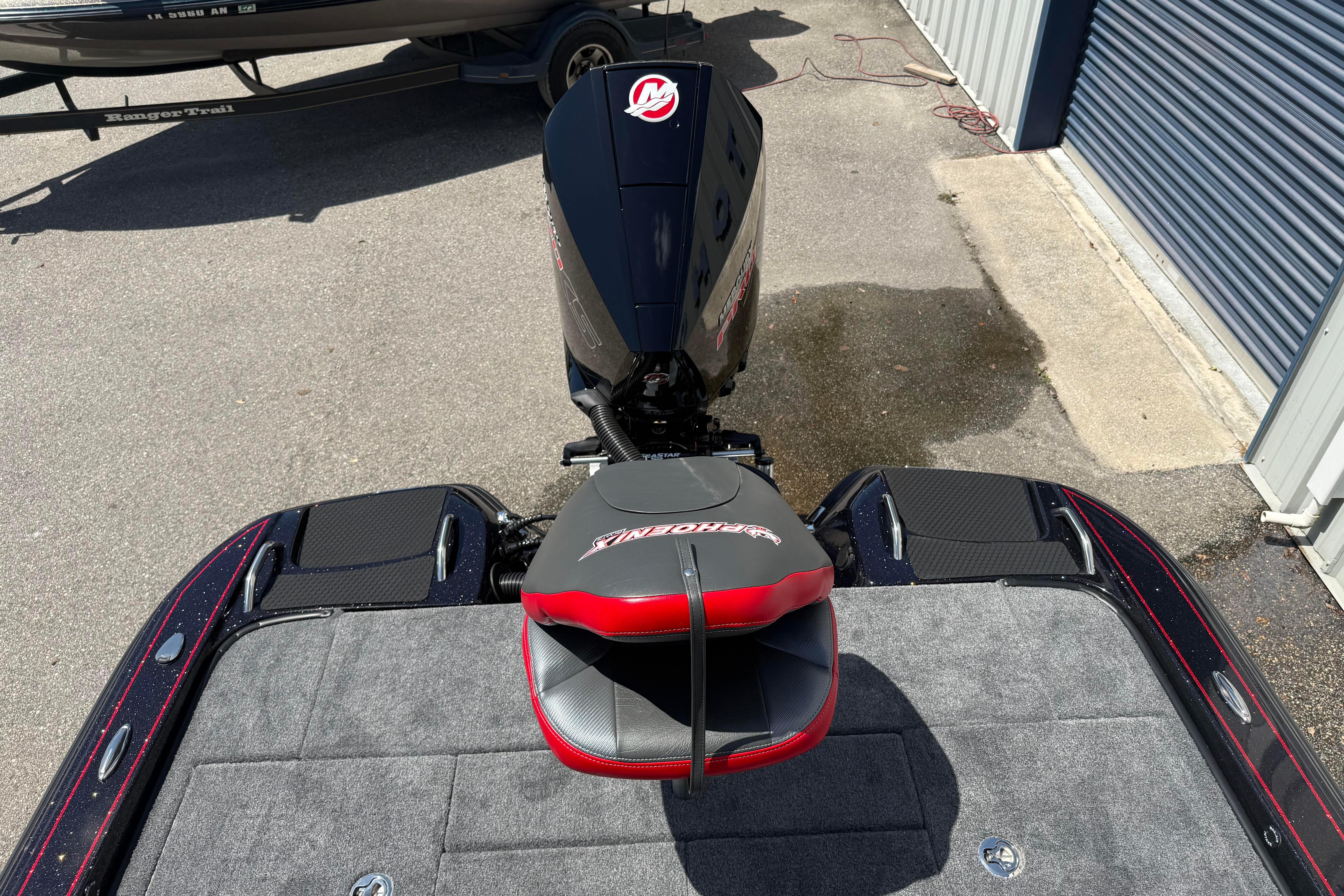 Rear view of a 2027 Phoenix 919 ZXL boat with motor and seating.
