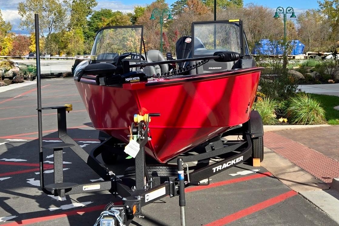 2026 Tracker Targa V-19 Combo boat in vibrant red on a trailer, outdoors.