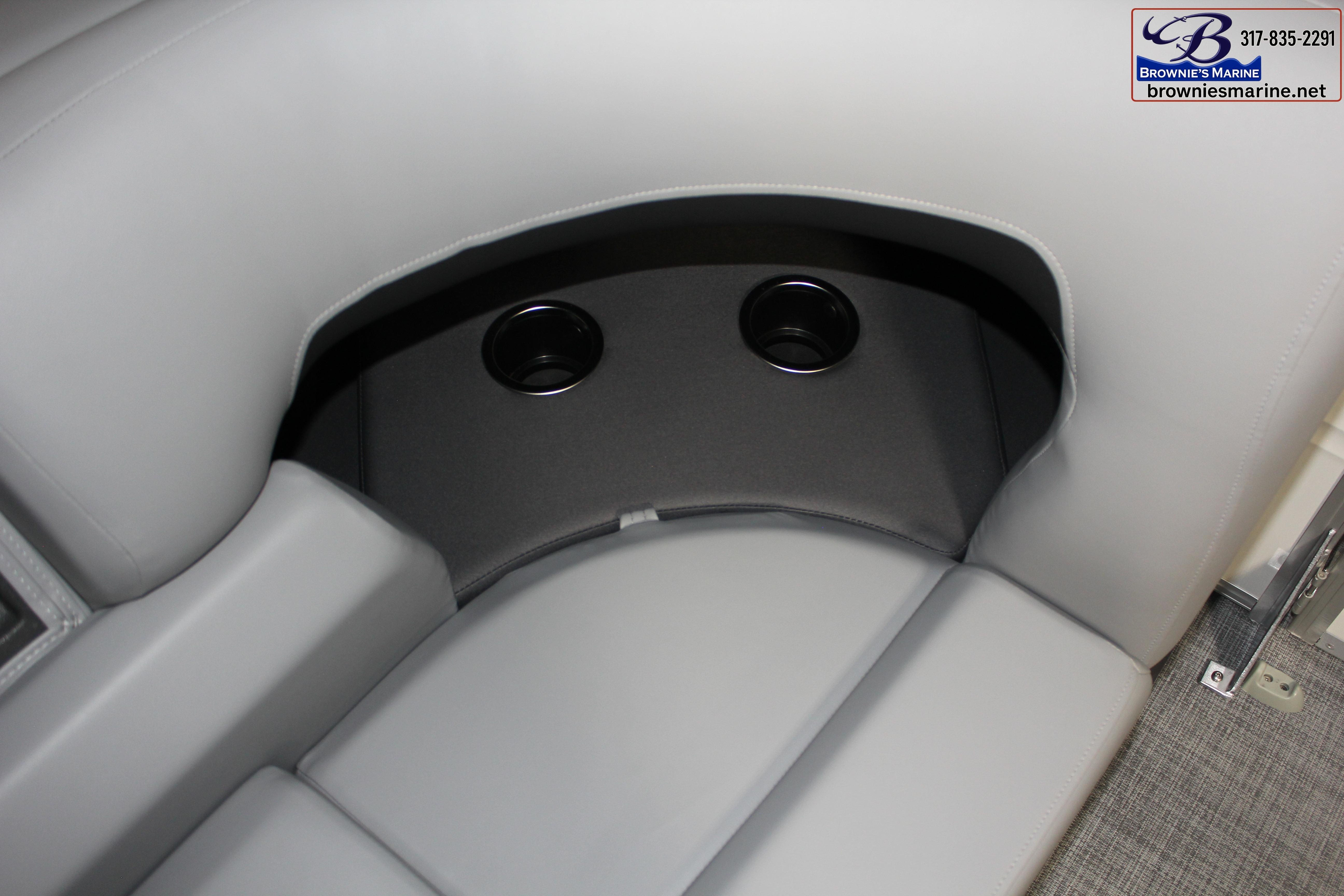 2026 Sun Tracker Party Barge 22 DLX interior with cup holders and gray seating.