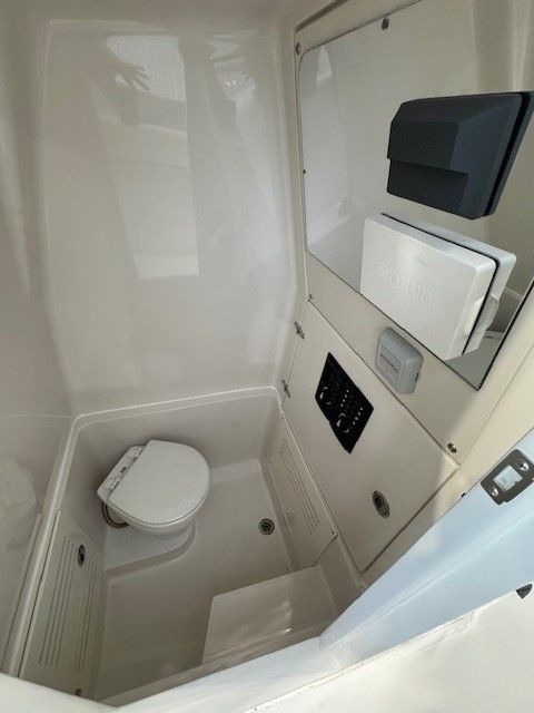 Interior of 2020 Jupiter 26 FS Center Console with toilet.