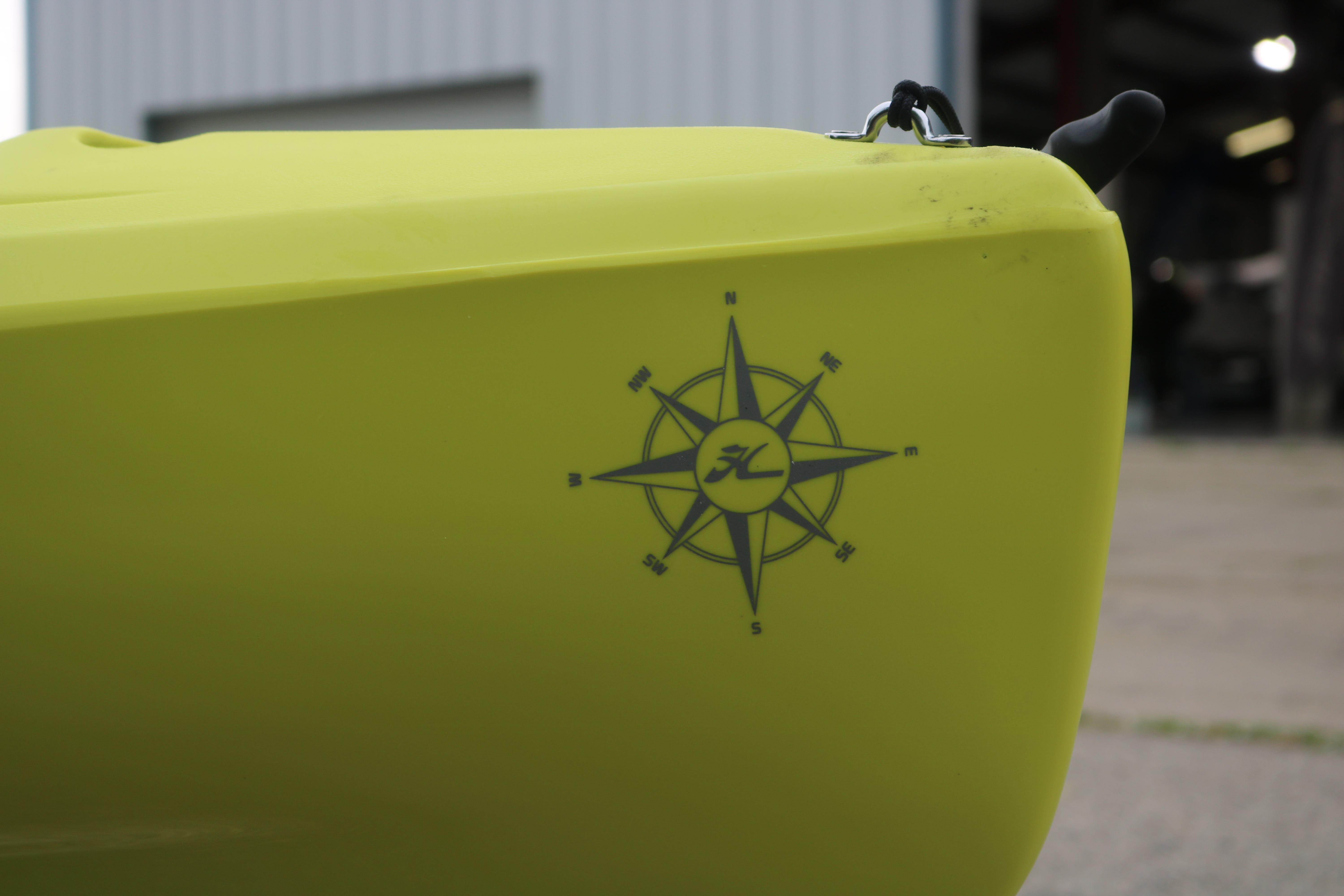 Yellow 2025 Hobie Mirage Compass kayak with compass design on the side.