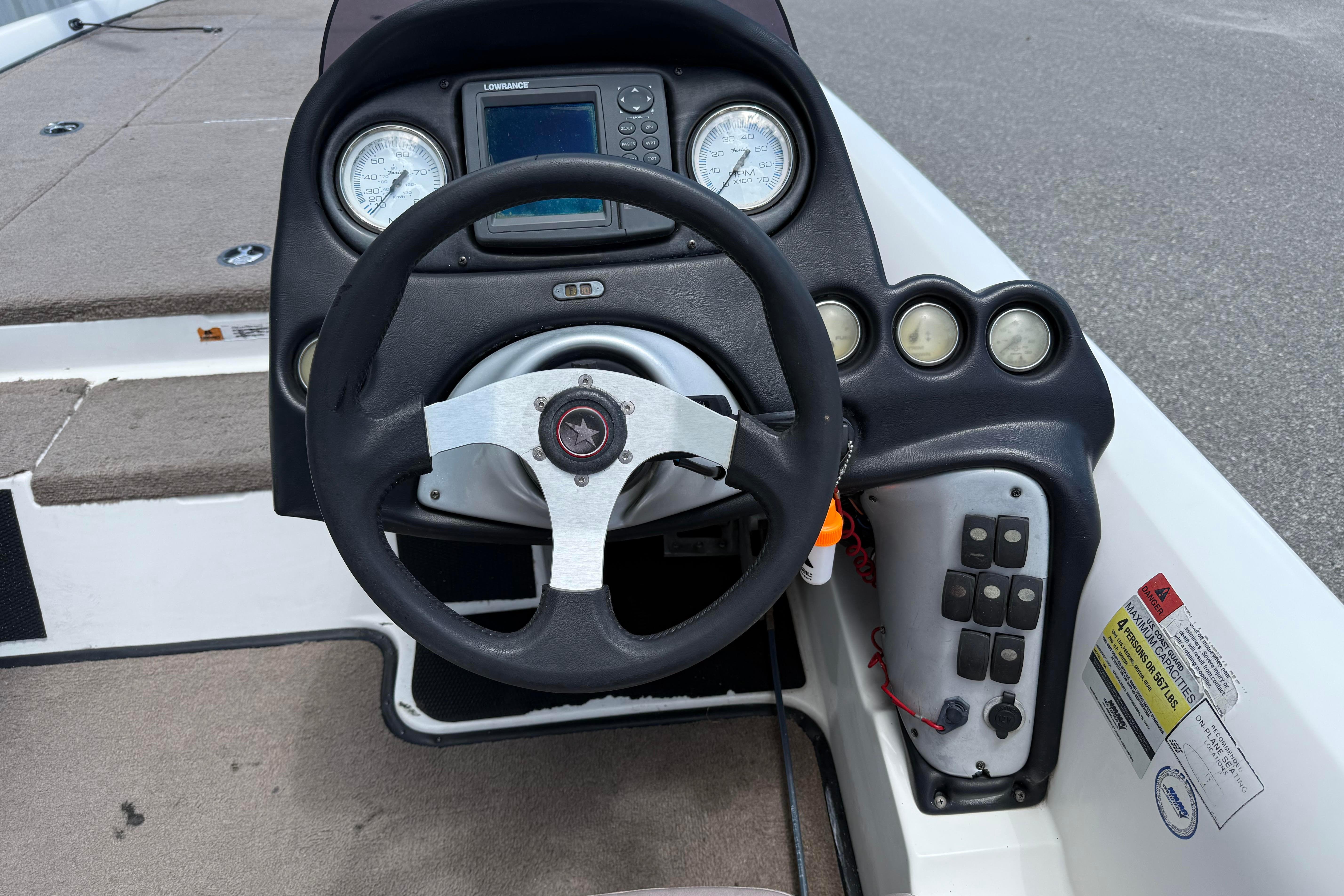 2006 Stratos 294 Pro XL boat dashboard with steering wheel and gauges.