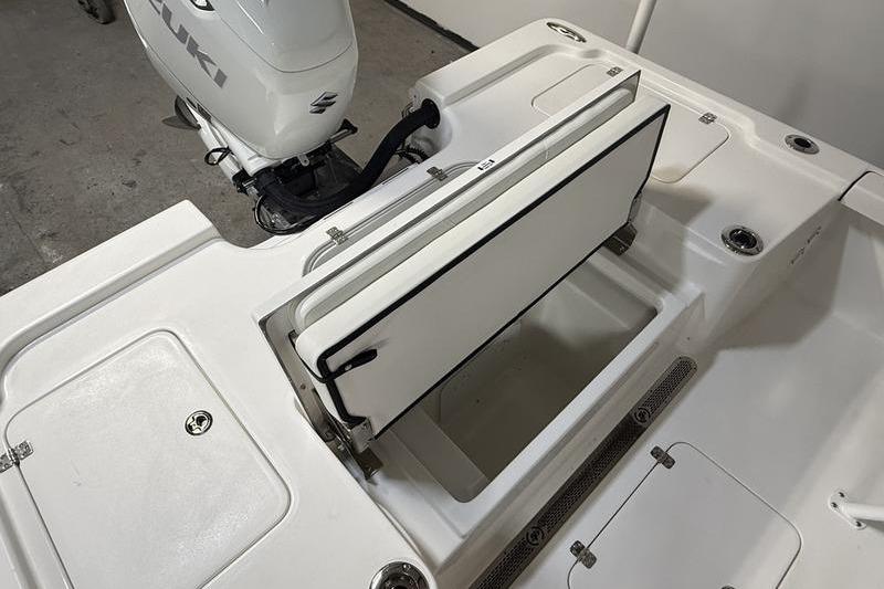 2026 Sea Pro 250 Bay boat with open storage compartment and Suzuki outboard motor.