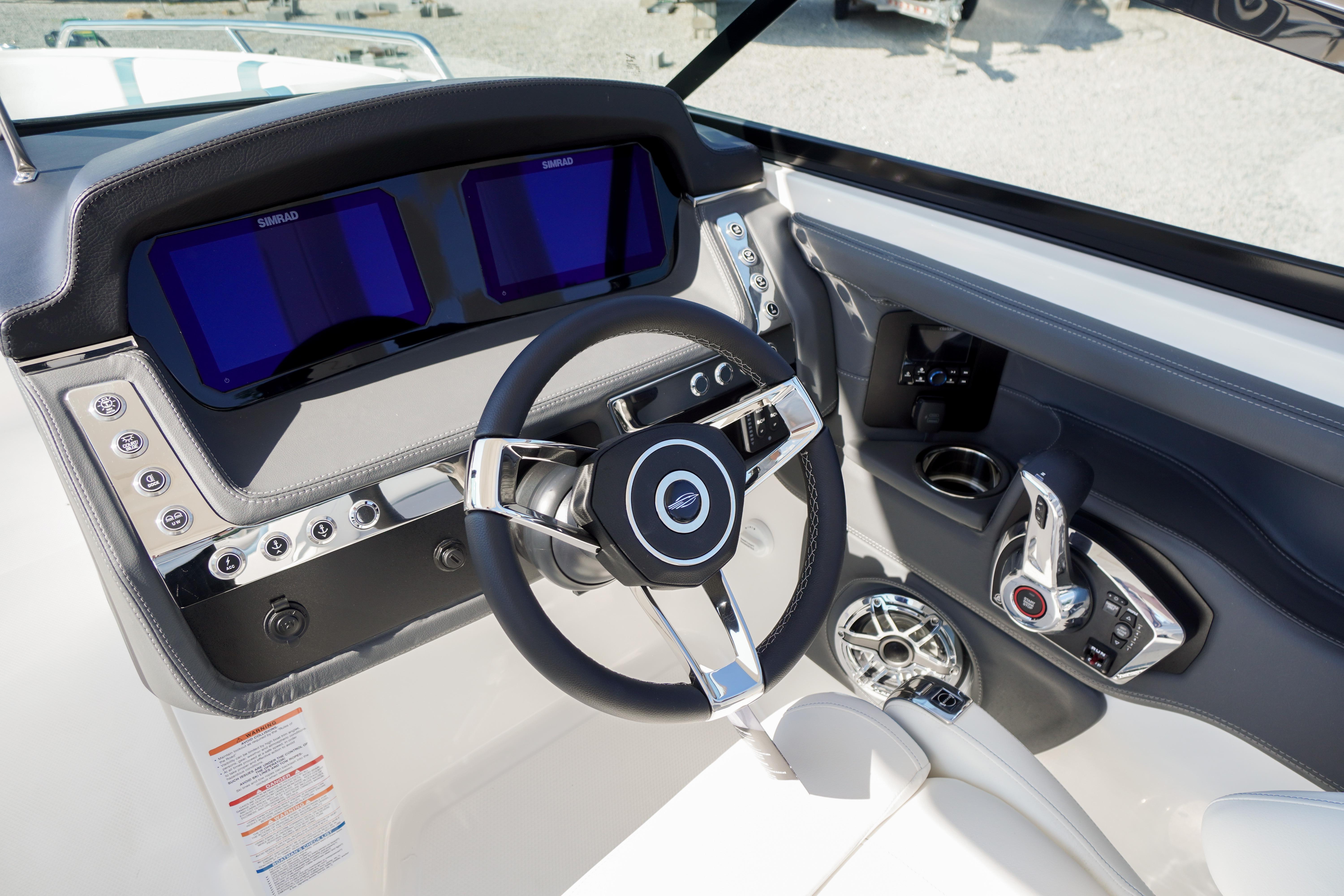 2026 Chaparral 270 OSX boat dashboard with modern steering wheel and dual displays.