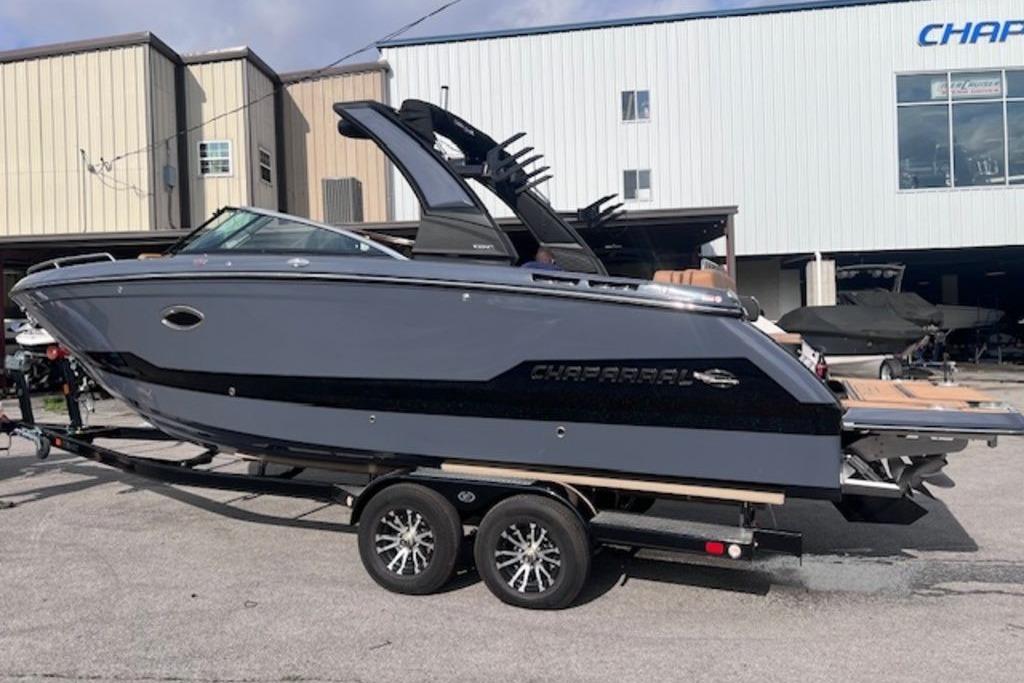 2025 Chaparral 2870 SSX boat on trailer, parked outside a building.