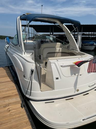 2008 Chaparral Signature 310 boat docked with blue canopy.