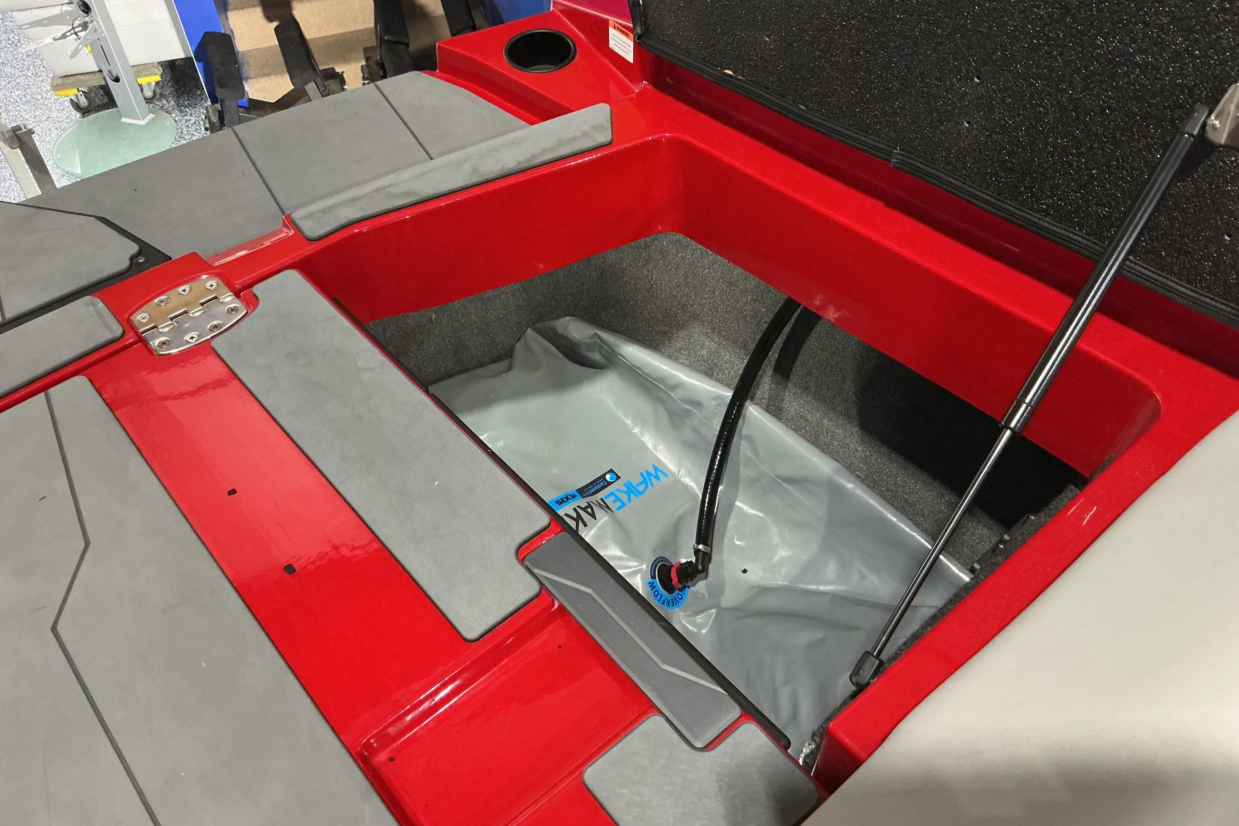 2022 Axis T250 boat storage compartment with ballast bag and hydraulic lift.