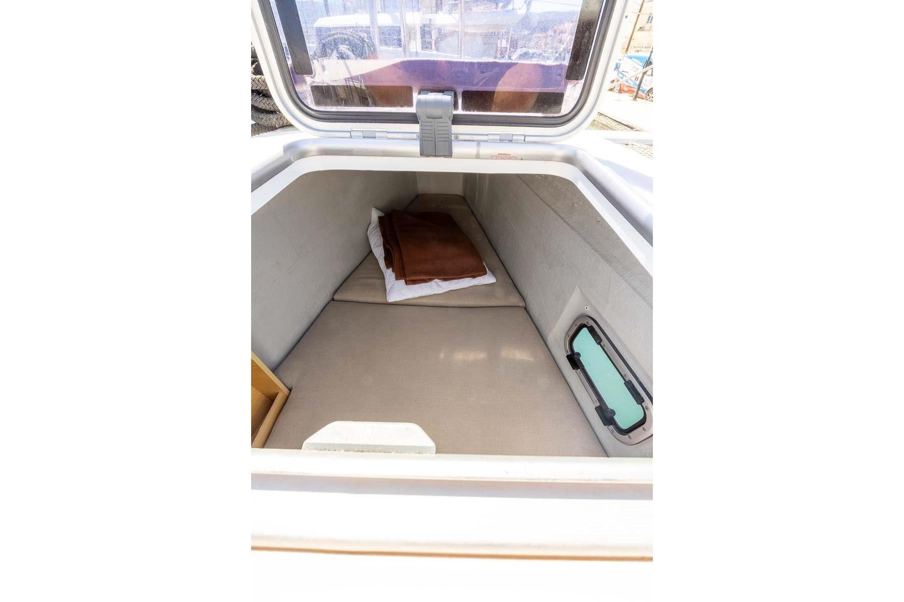 Interior cabin view of a 2016 Lagoon 39 catamaran, featuring a cozy sleeping area.