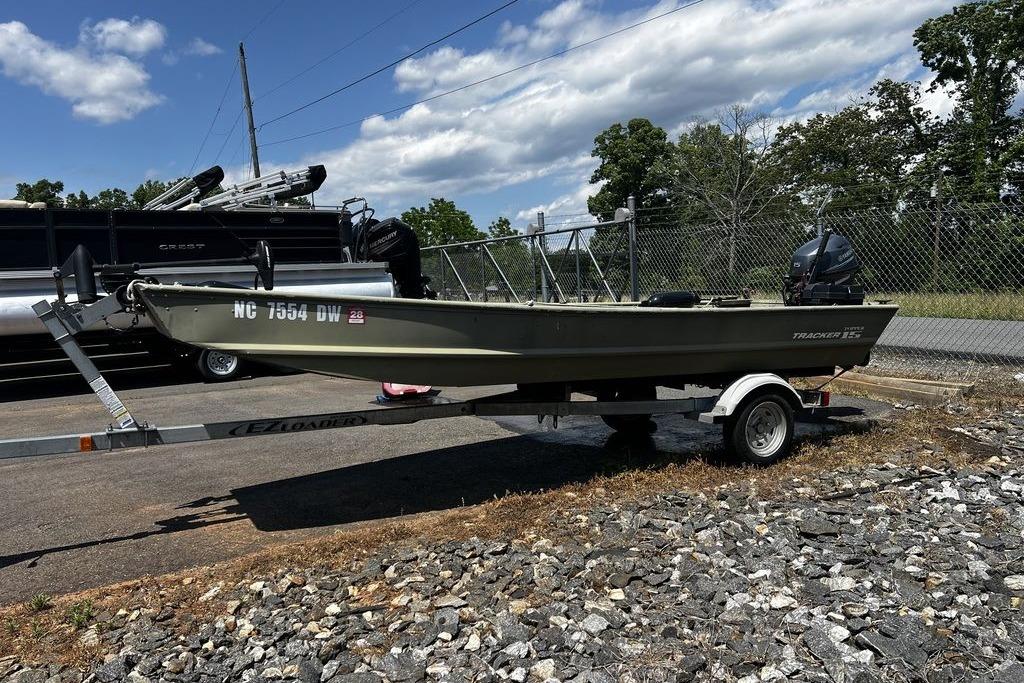 2012 Tracker Topper 1542 LW Riveted Jon boat on trailer, parked outdoors.