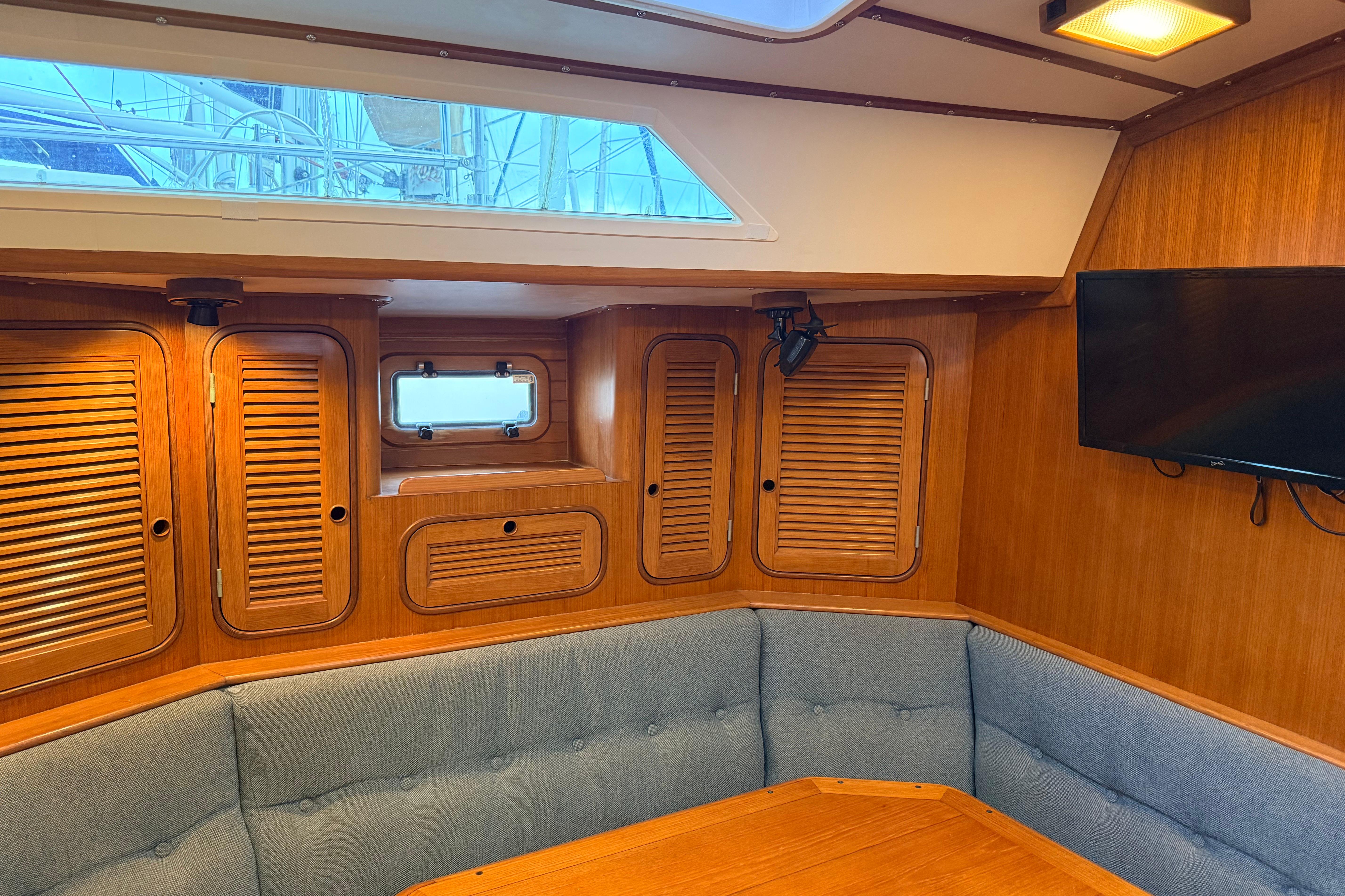 Interior of 1987 Norseman 400 yacht with wood paneling and seating area.