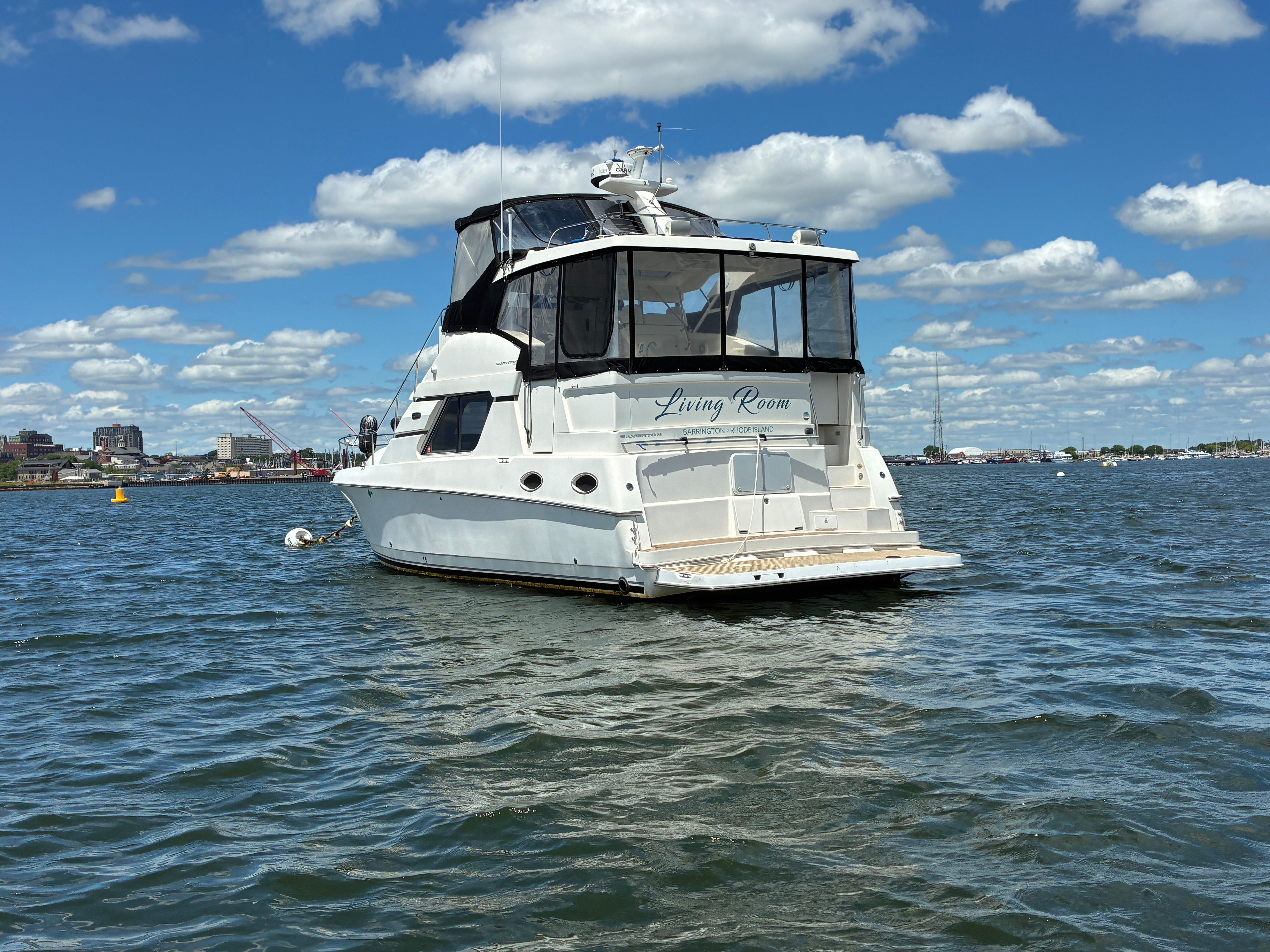 2001 Silverton 392 Motor Yacht on calm water under a blue sky with white clouds.