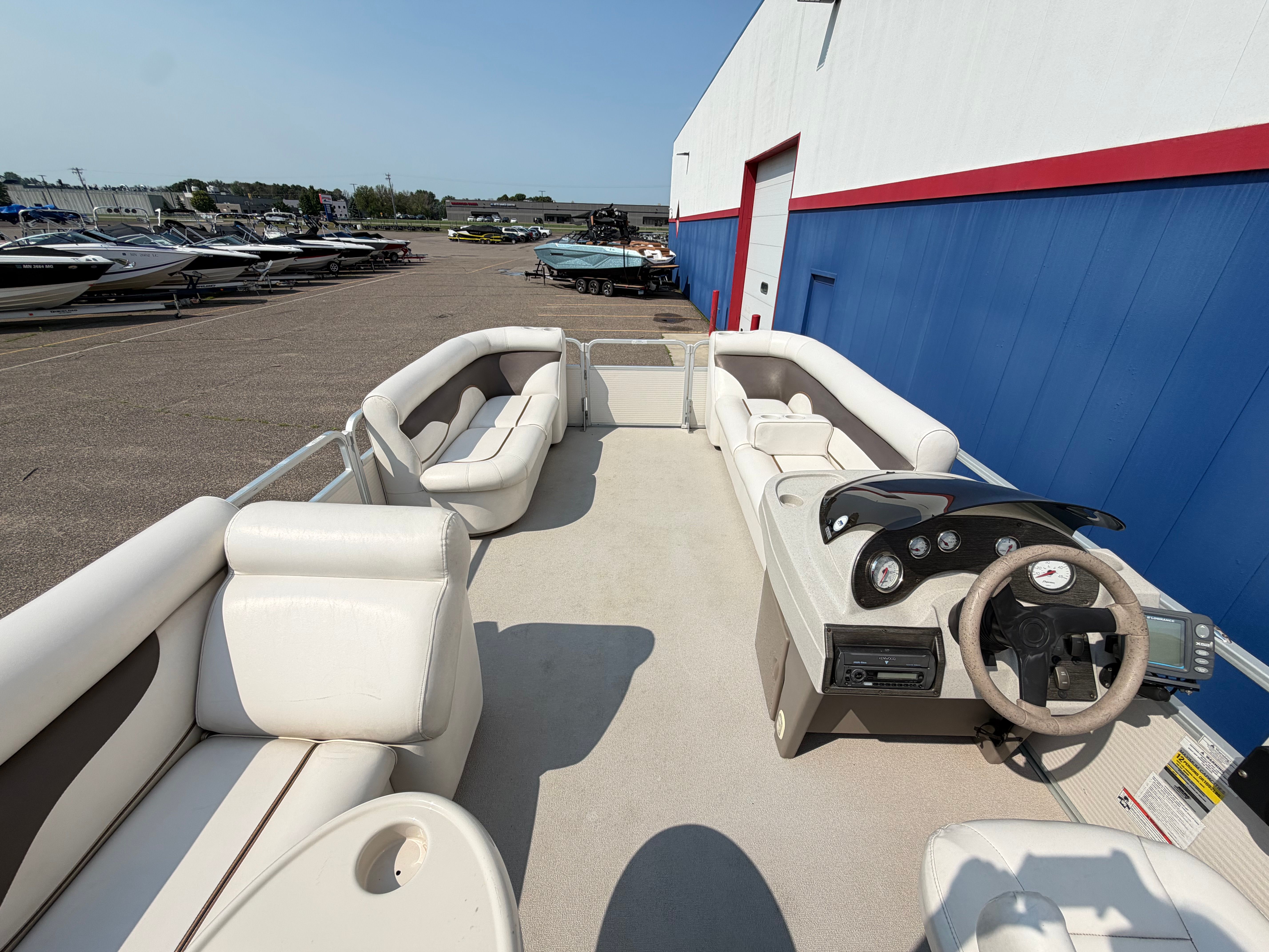 2007 Premier 225 Sunsation pontoon boat with spacious deck and comfortable seating.