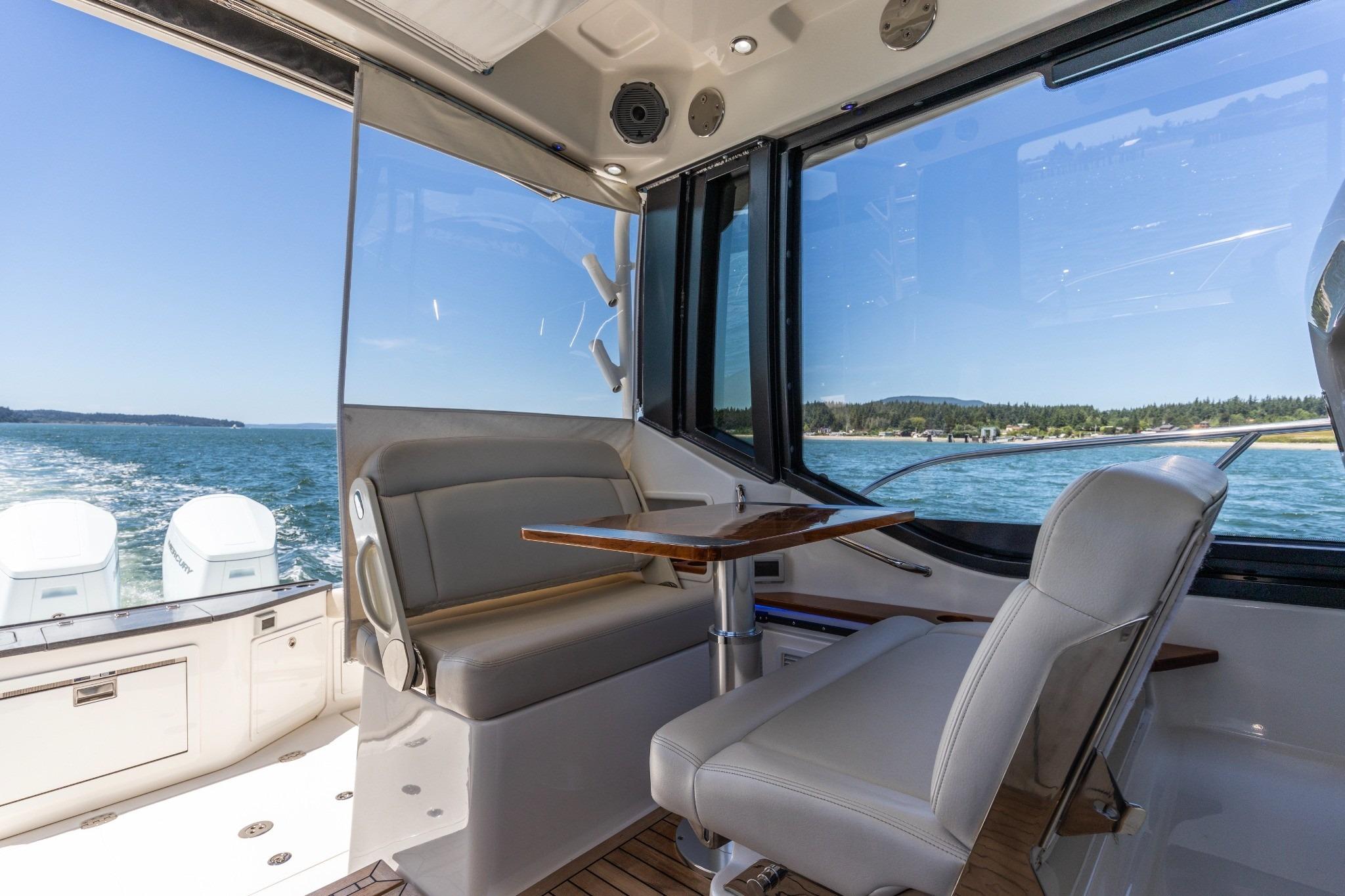 Interior of 2023 Boston Whaler 405 Conquest boat with seating and ocean view.