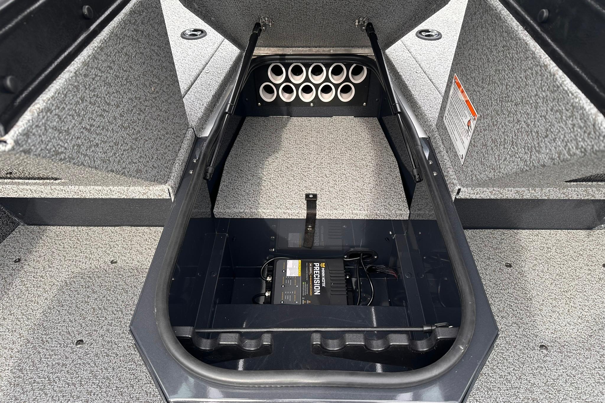 2026 Lund 1775 Adventure Sport boat storage compartment with battery and rod holders.