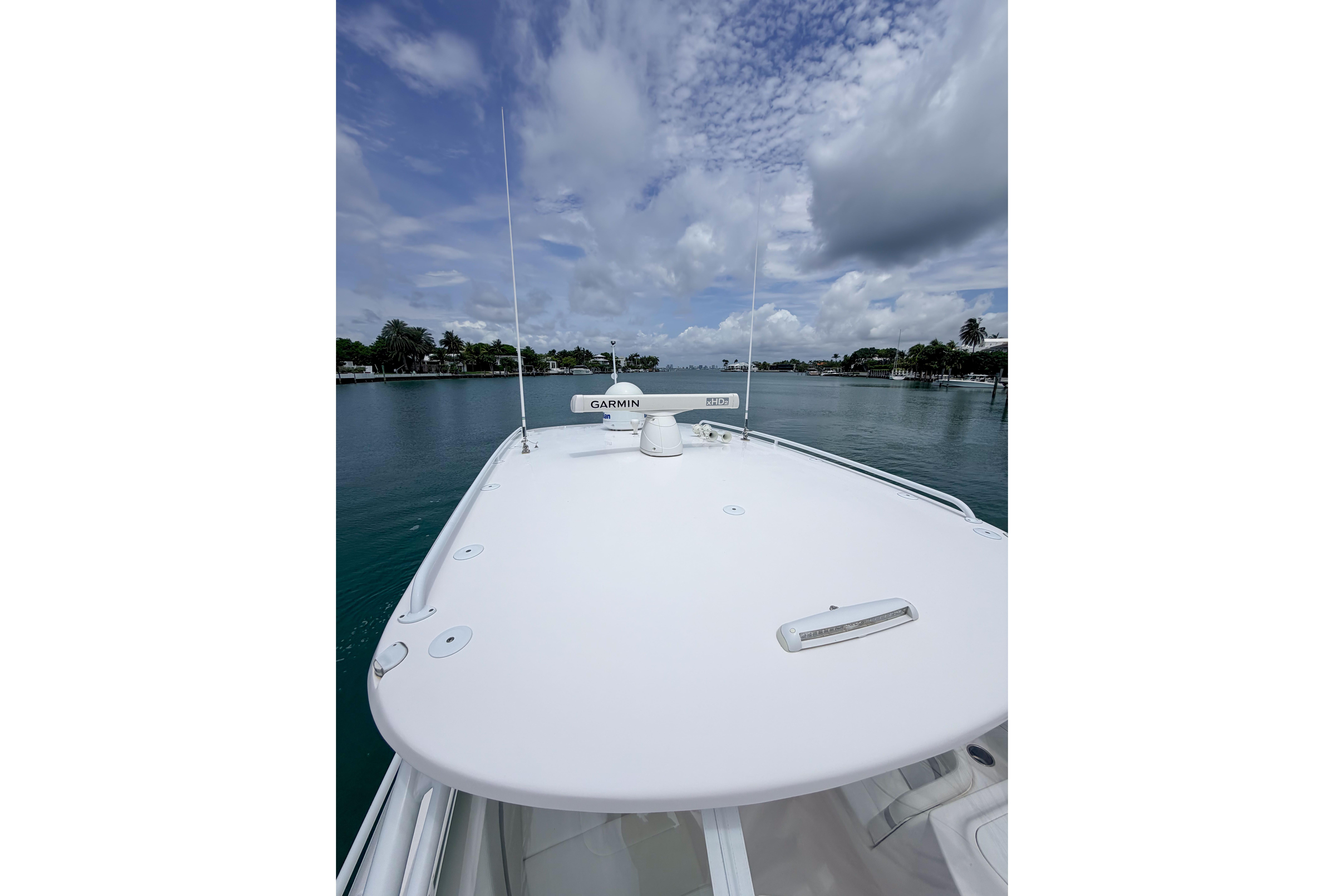 2021 Intrepid 409 Valor boat deck with Garmin equipment, cruising on a calm waterway.