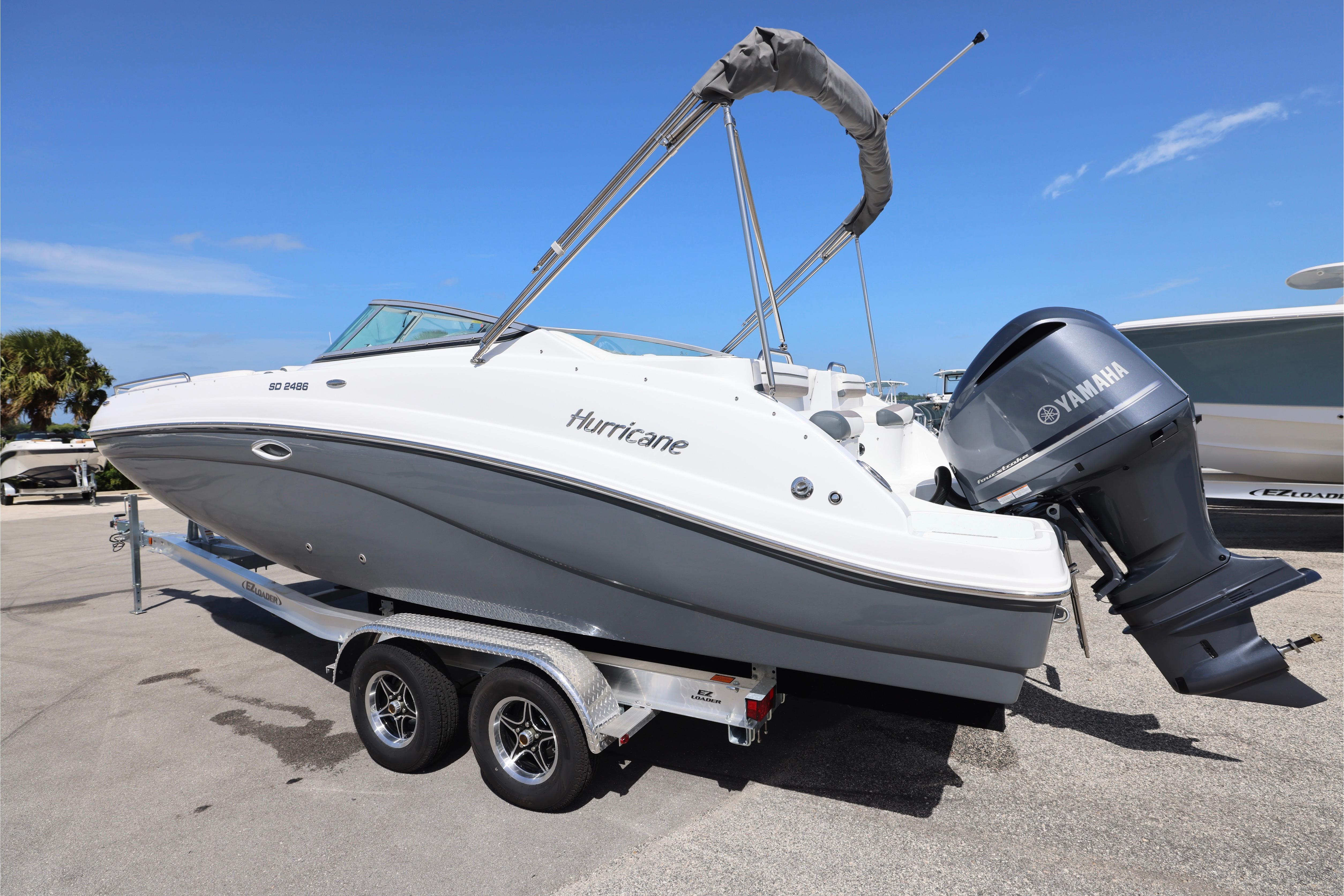 2026 Hurricane SunDeck 2486 OB boat on trailer with Yamaha outboard motor.