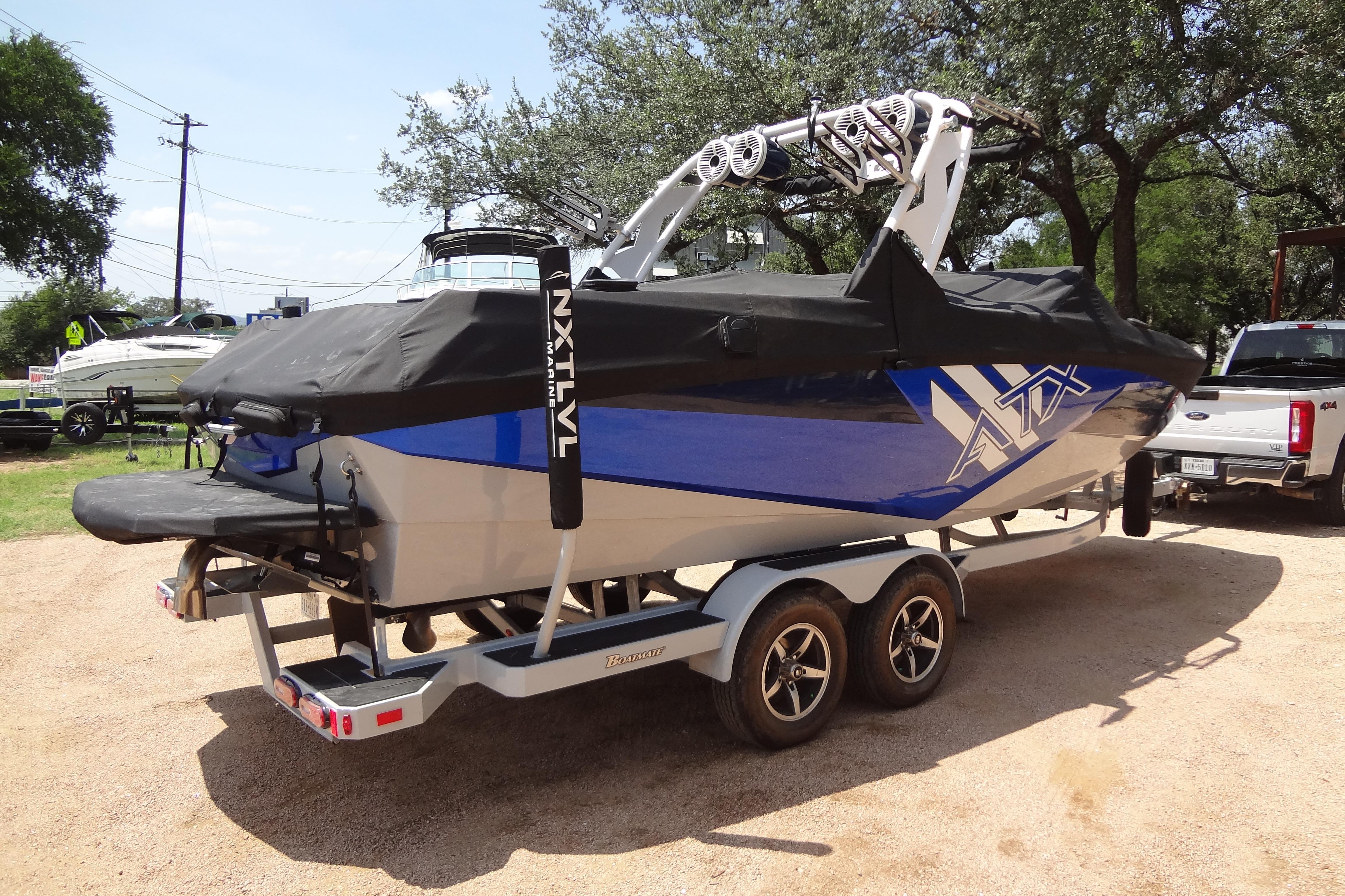 2022 ATX Surf Boats 24 Type-S on trailer, covered, in outdoor setting.