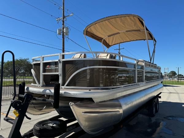2025 Sun Tracker 24 Sportfish XP3 pontoon boat with canopy on trailer.