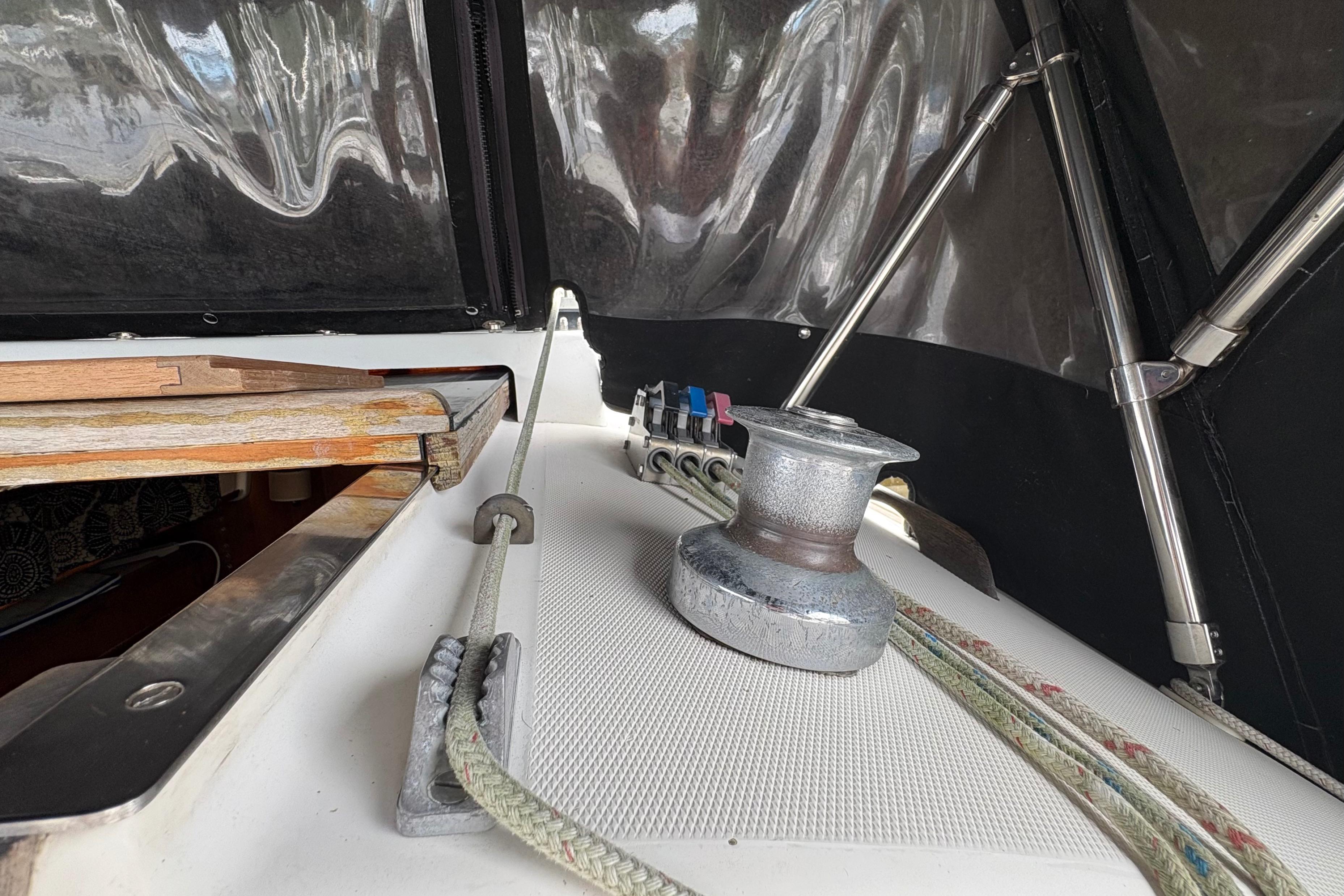 1981 Sabre 31 sailboat deck with winch, ropes, and cabin entrance.