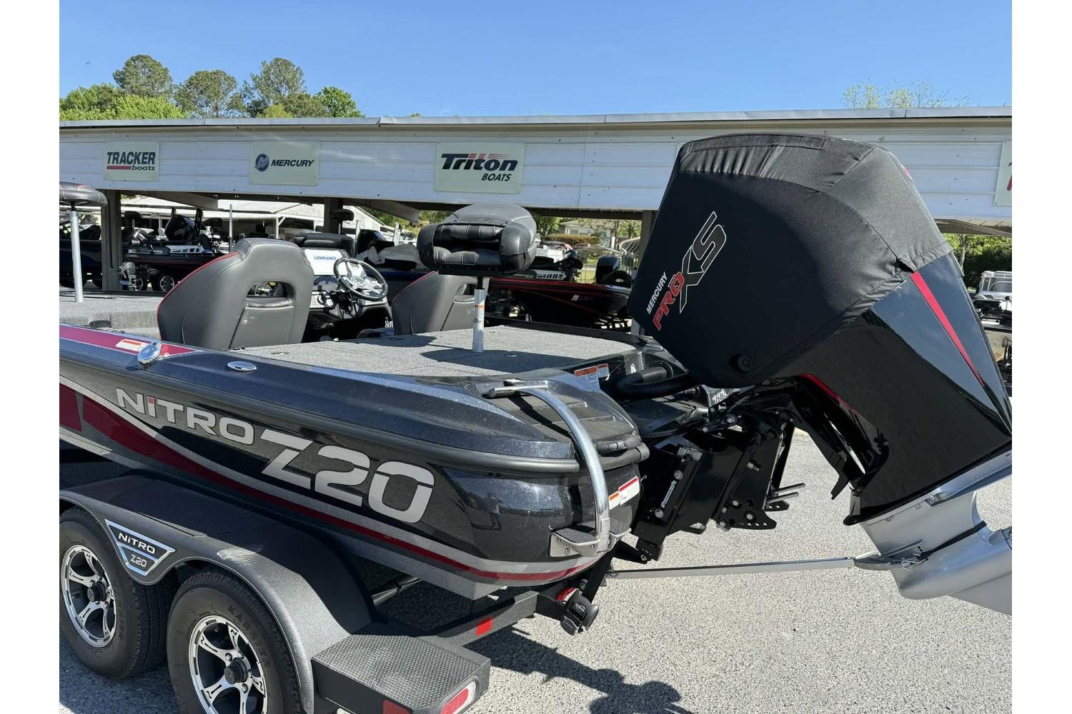 2023 Nitro Z20 Pro boat with Mercury engine cover, parked at dealership.