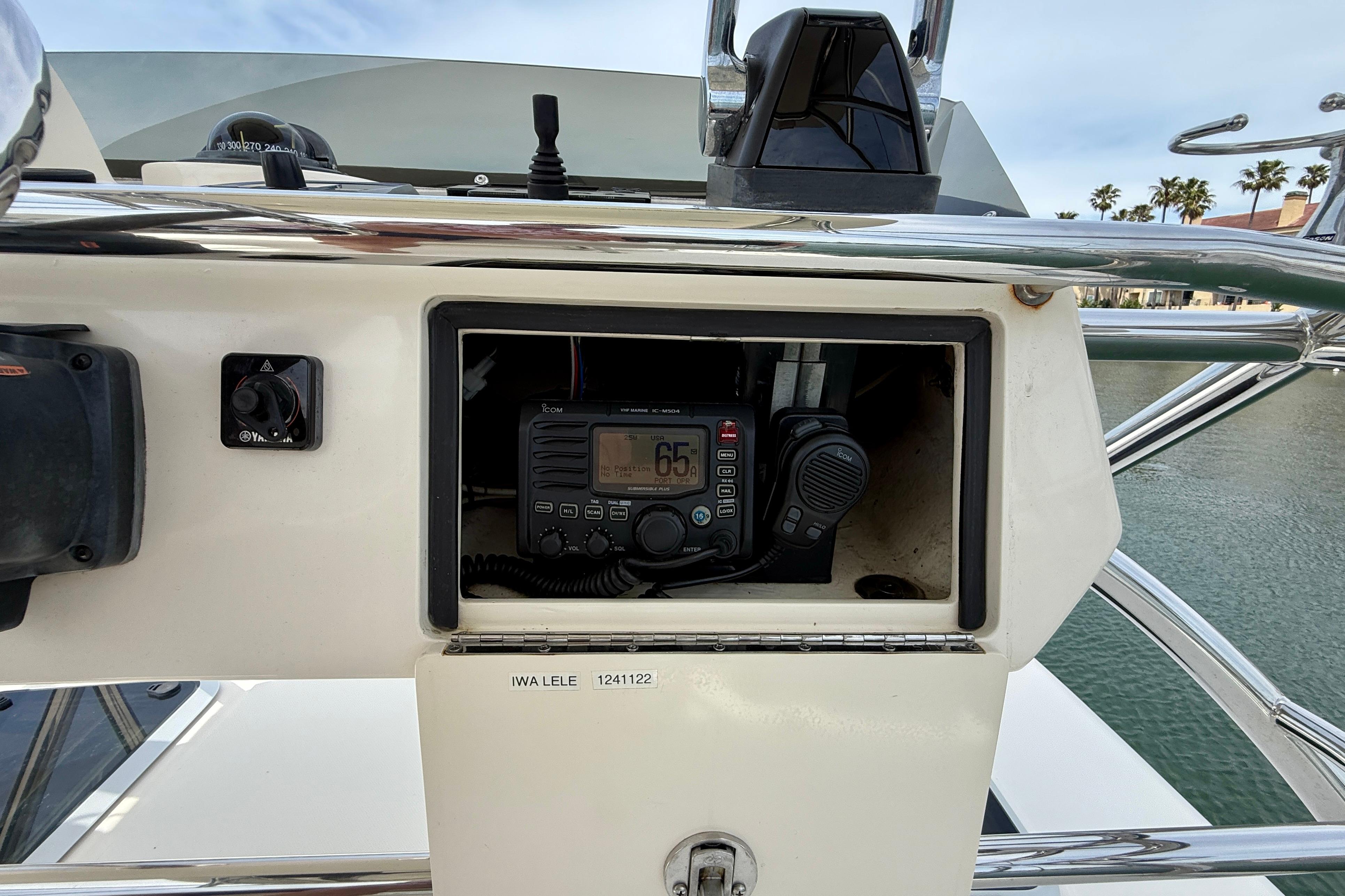 Control panel of a 2012 Pursuit OS 345 Offshore boat with radio equipment.
