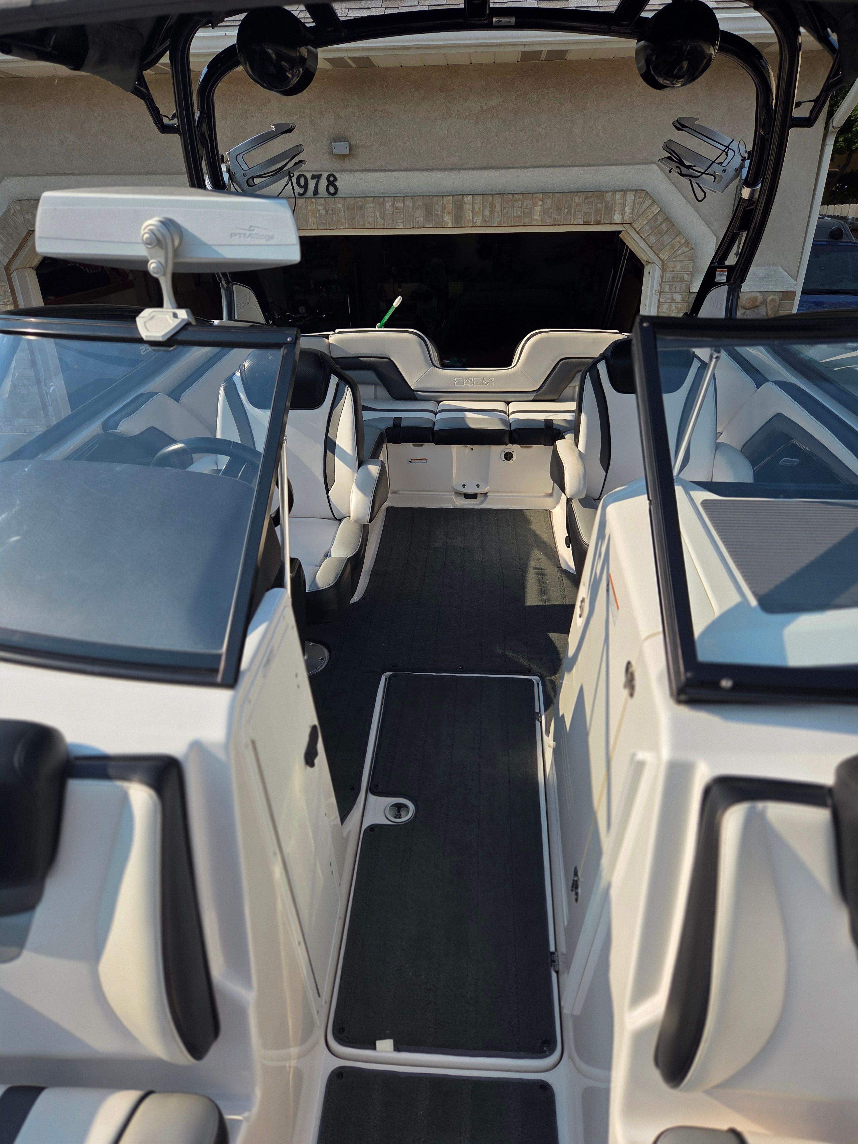 Interior view of a 2016 Yamaha 242X E-Series boat with seating and helm console.