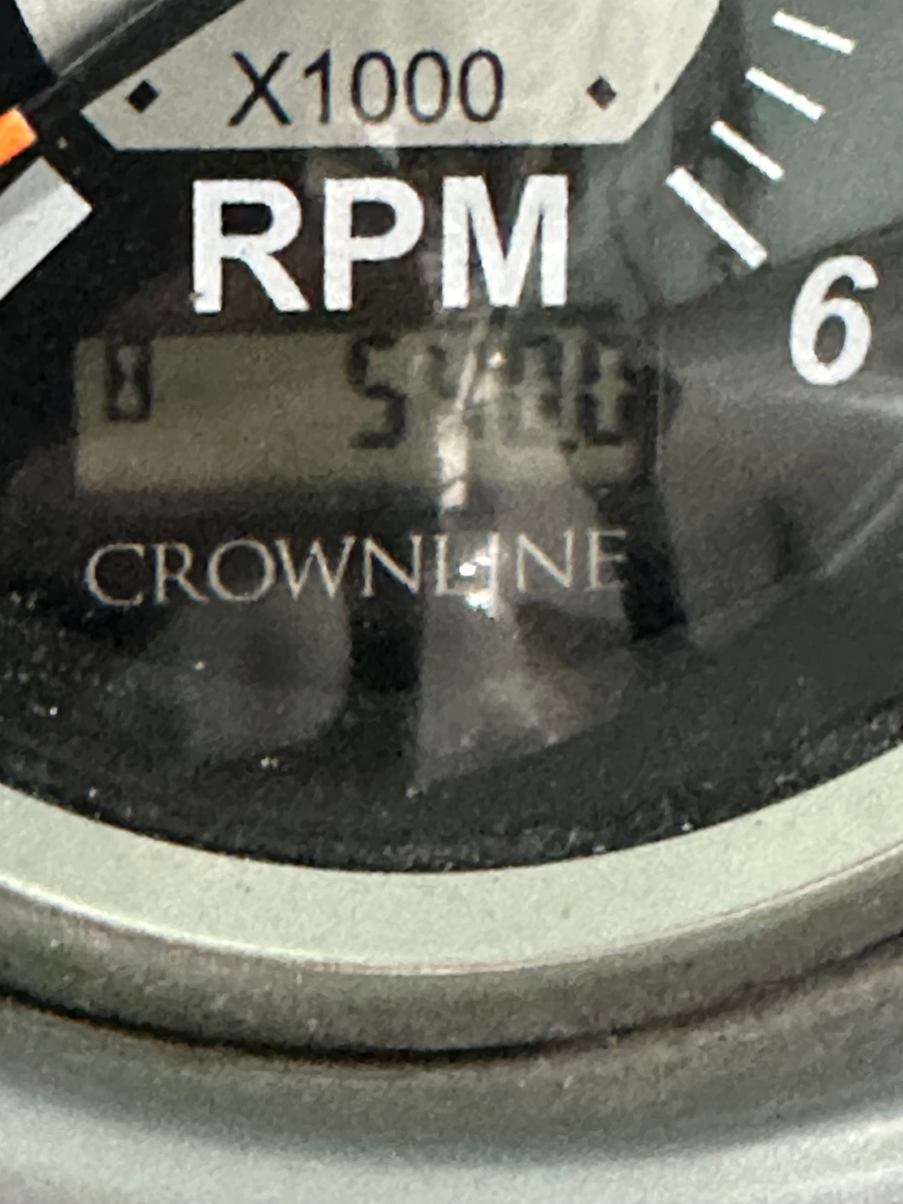 Close-up of a tachometer displaying "Crownline" and showing 5400 RPM.