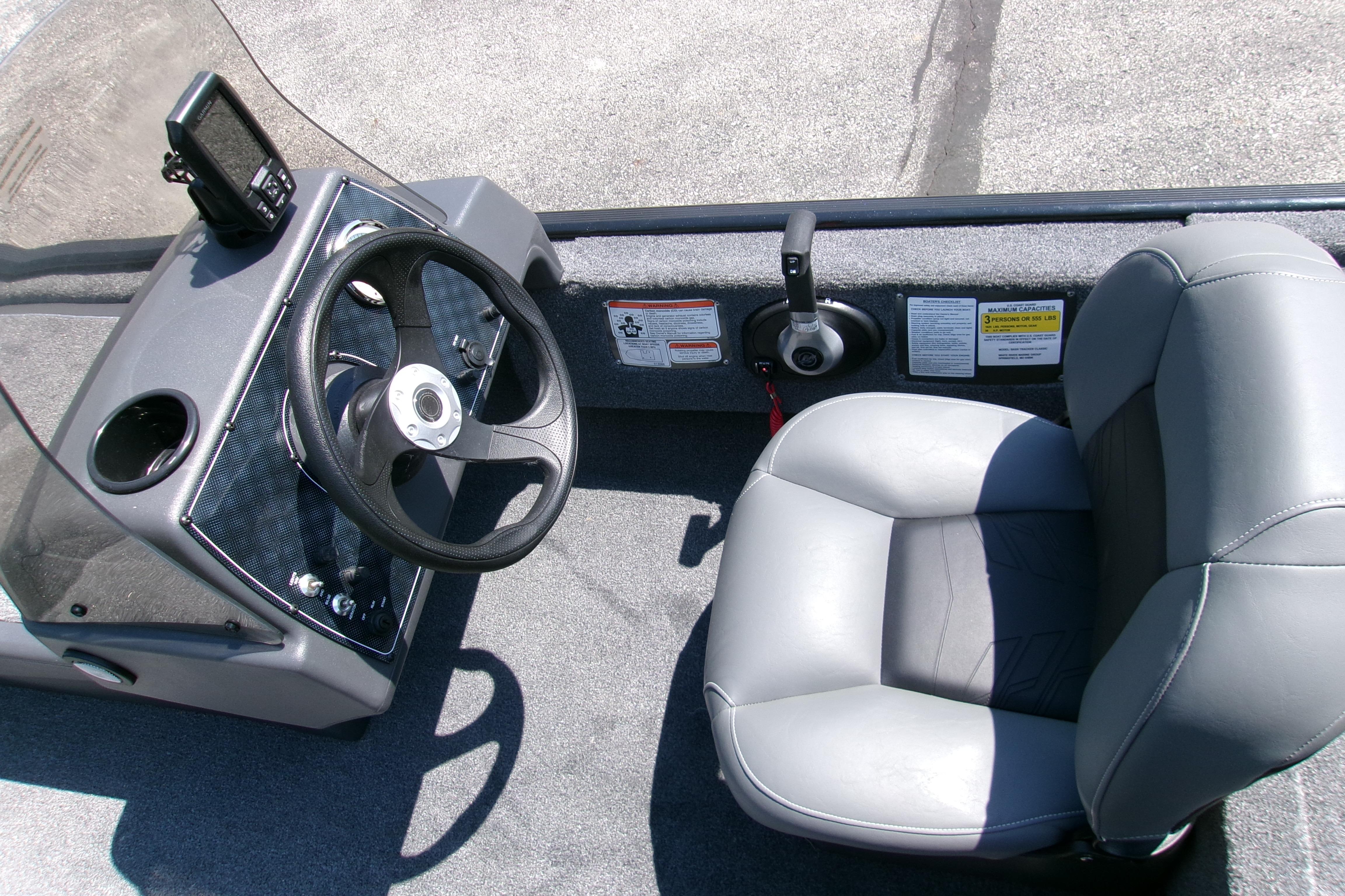 2026 Tracker Bass Tracker Classic XL boat interior with steering wheel and seat.