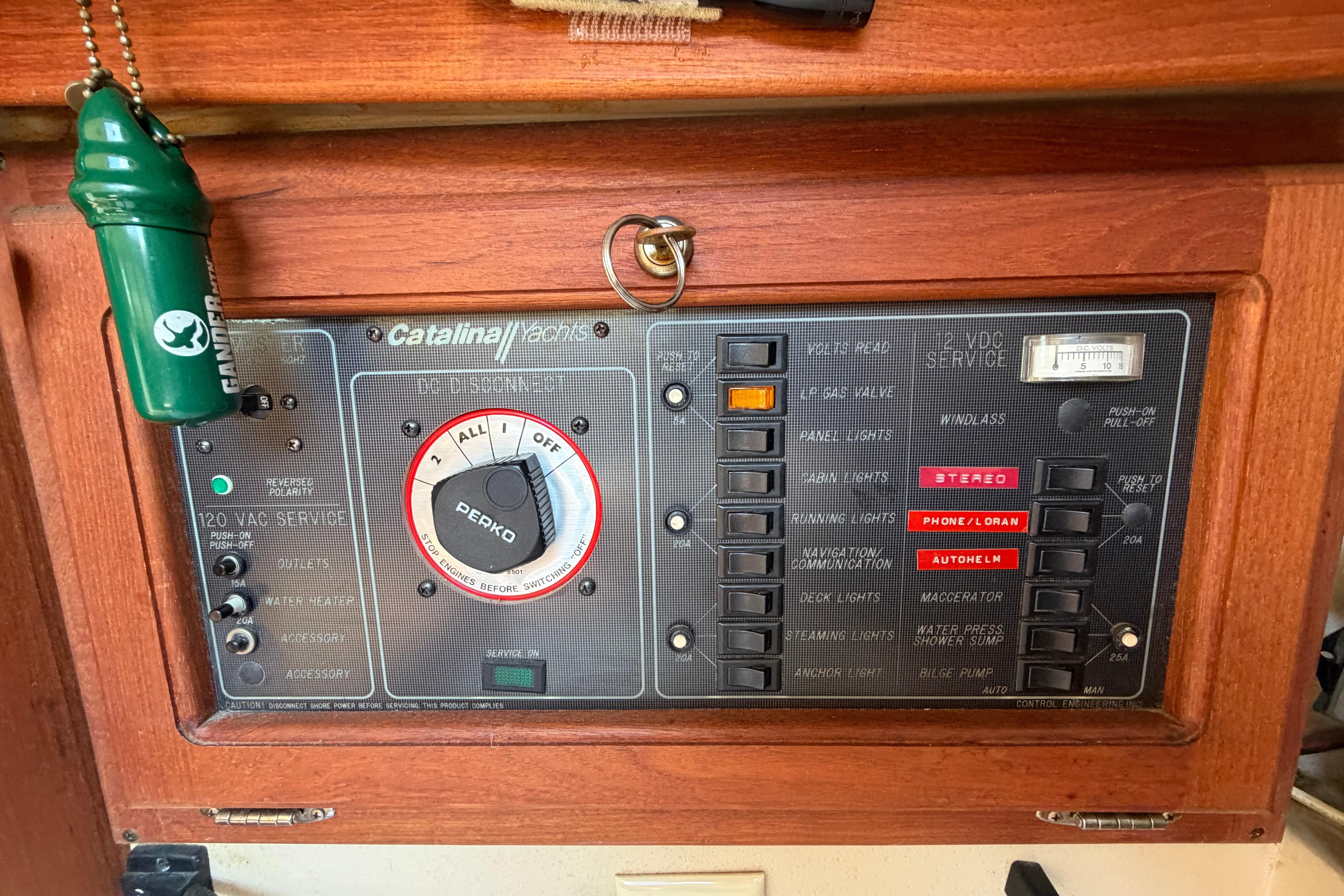 Electrical control panel of a 1988 Catalina 30 MkII sailboat, featuring various switches and gauges.
