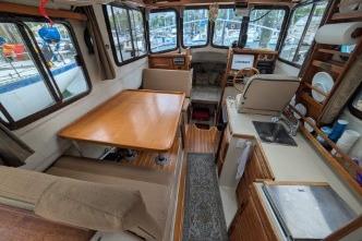 Interior of 2008 Ranger 25 with dining and kitchen area.