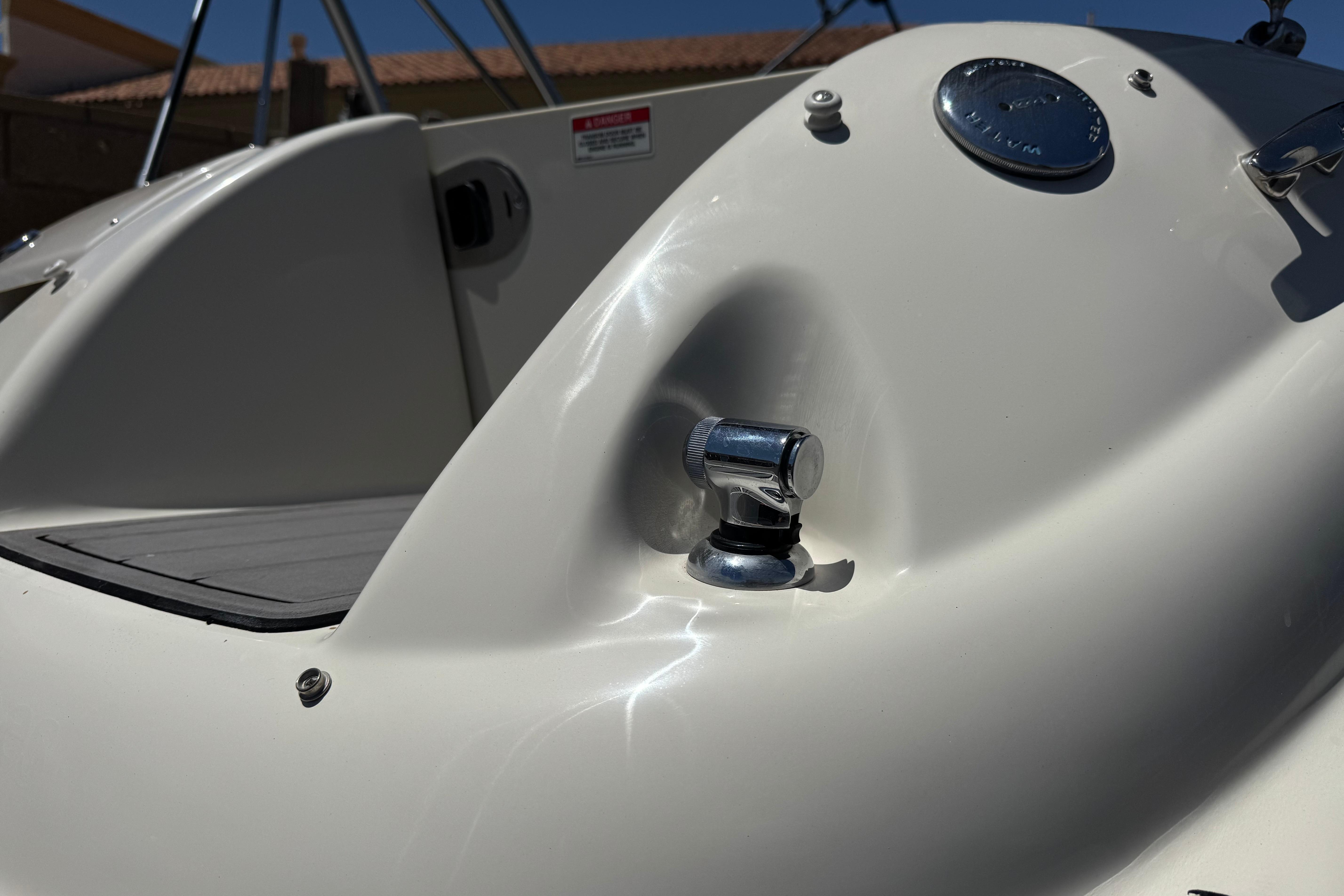 Close-up of a 2007 Sea Ray 240 Sundeck boat's deck detail with chrome fittings.