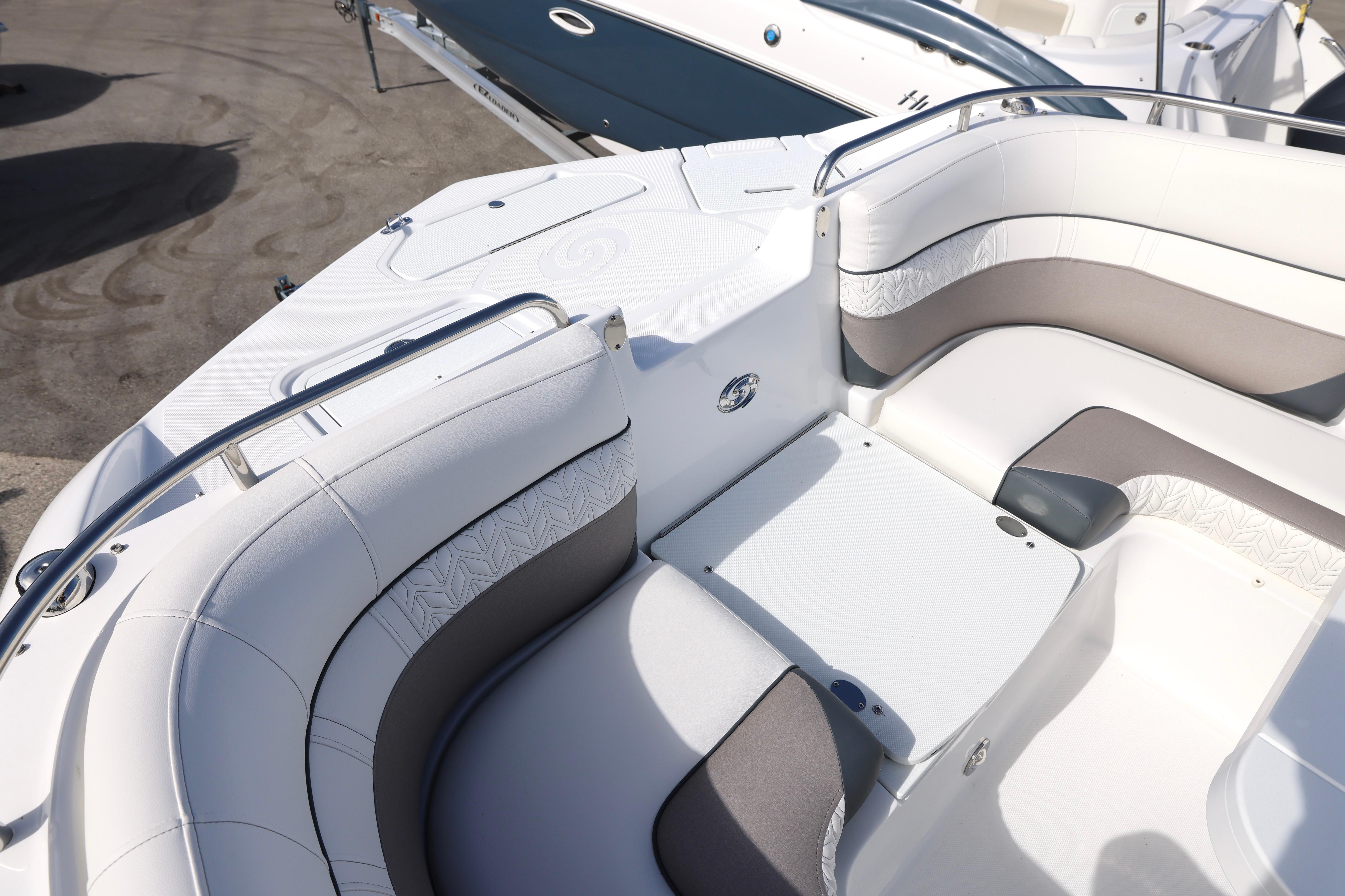 2026 Hurricane SunDeck 2486 OB boat interior with white and gray seating, showcasing luxury design.