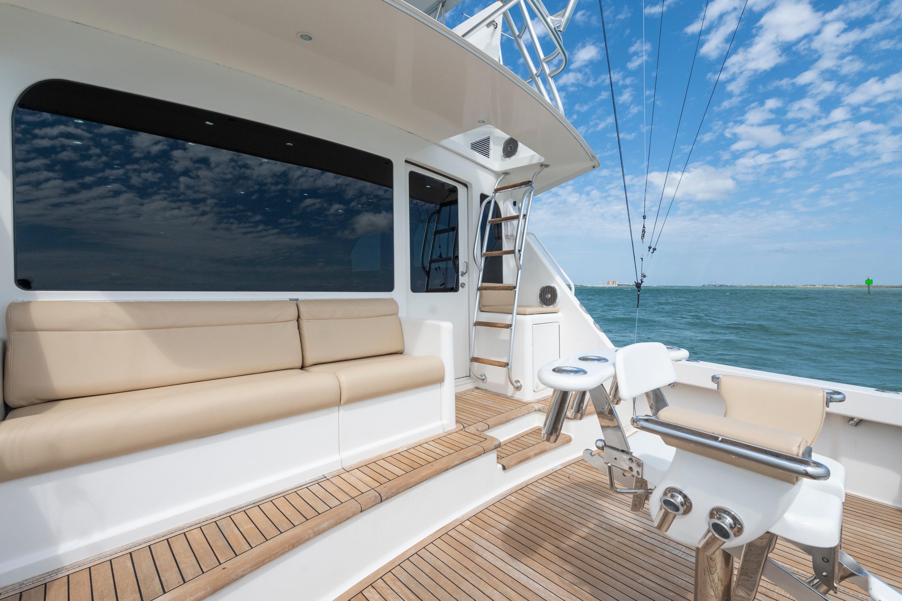 2009 Viking 50 Convertible yacht deck with seating, ocean view, and clear blue sky.