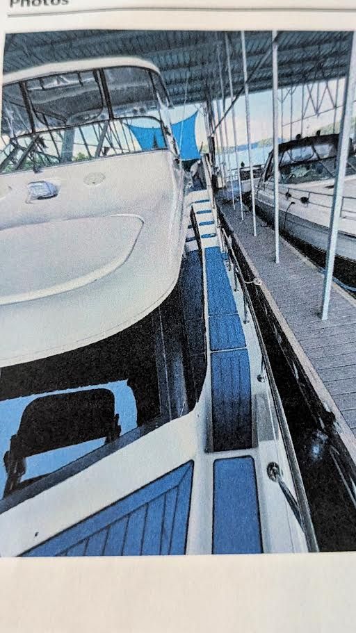 1996 Motor Yacht Blue Water docked in marina.