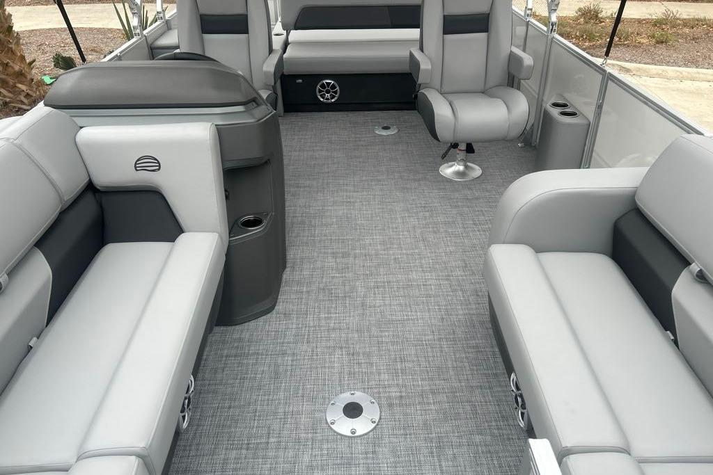 2026 Sun Tracker Party Barge 22 RF DLX interior with gray seating and flooring.