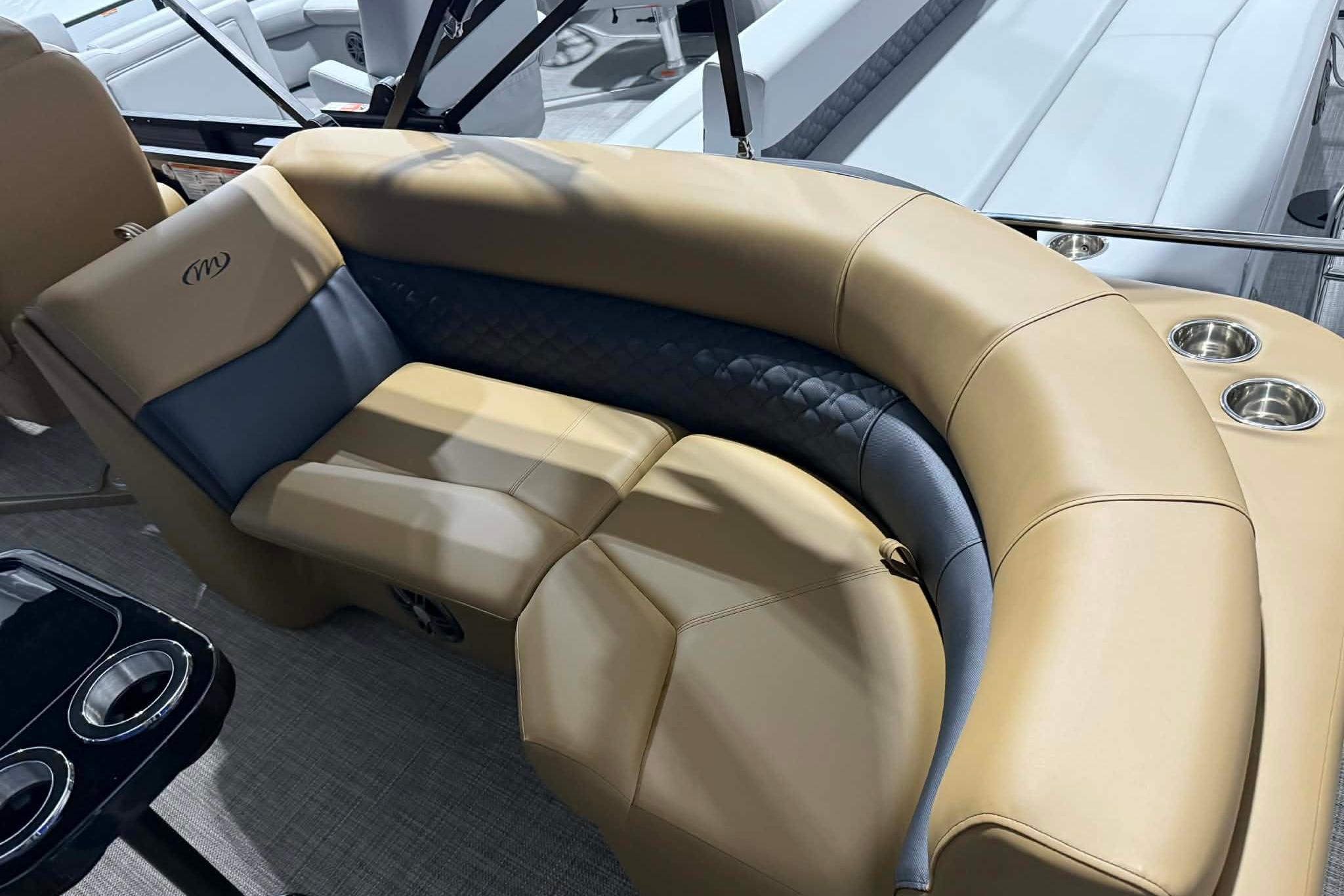 Luxurious seating on 2026 Manitou Encore VP 230 pontoon boat with cup holders.
