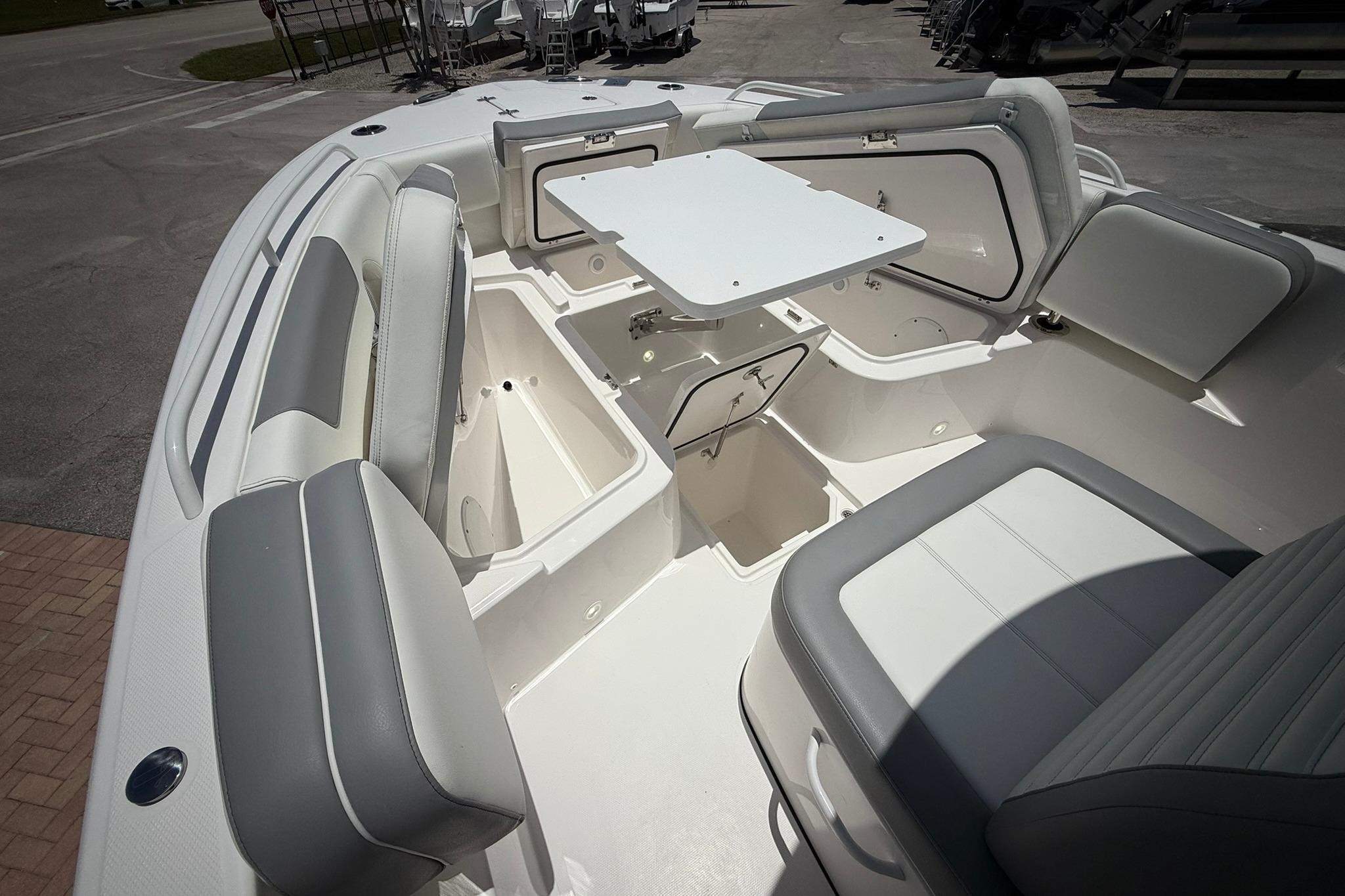 Interior view of 2026 Edgewater 250CC boat with seating and storage compartments.