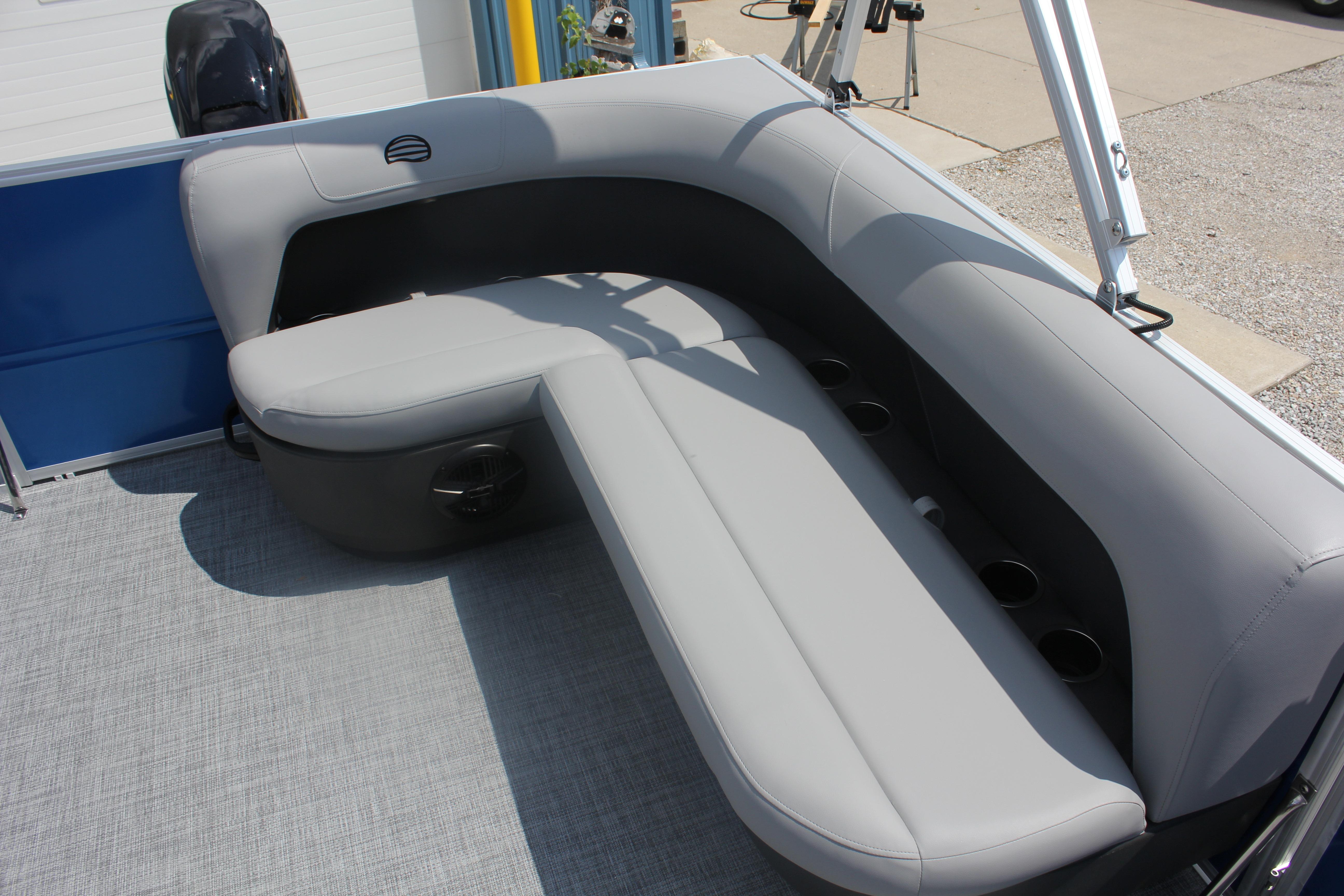 2026 Sun Tracker Party Barge 16 DLX with gray seating and cup holders.