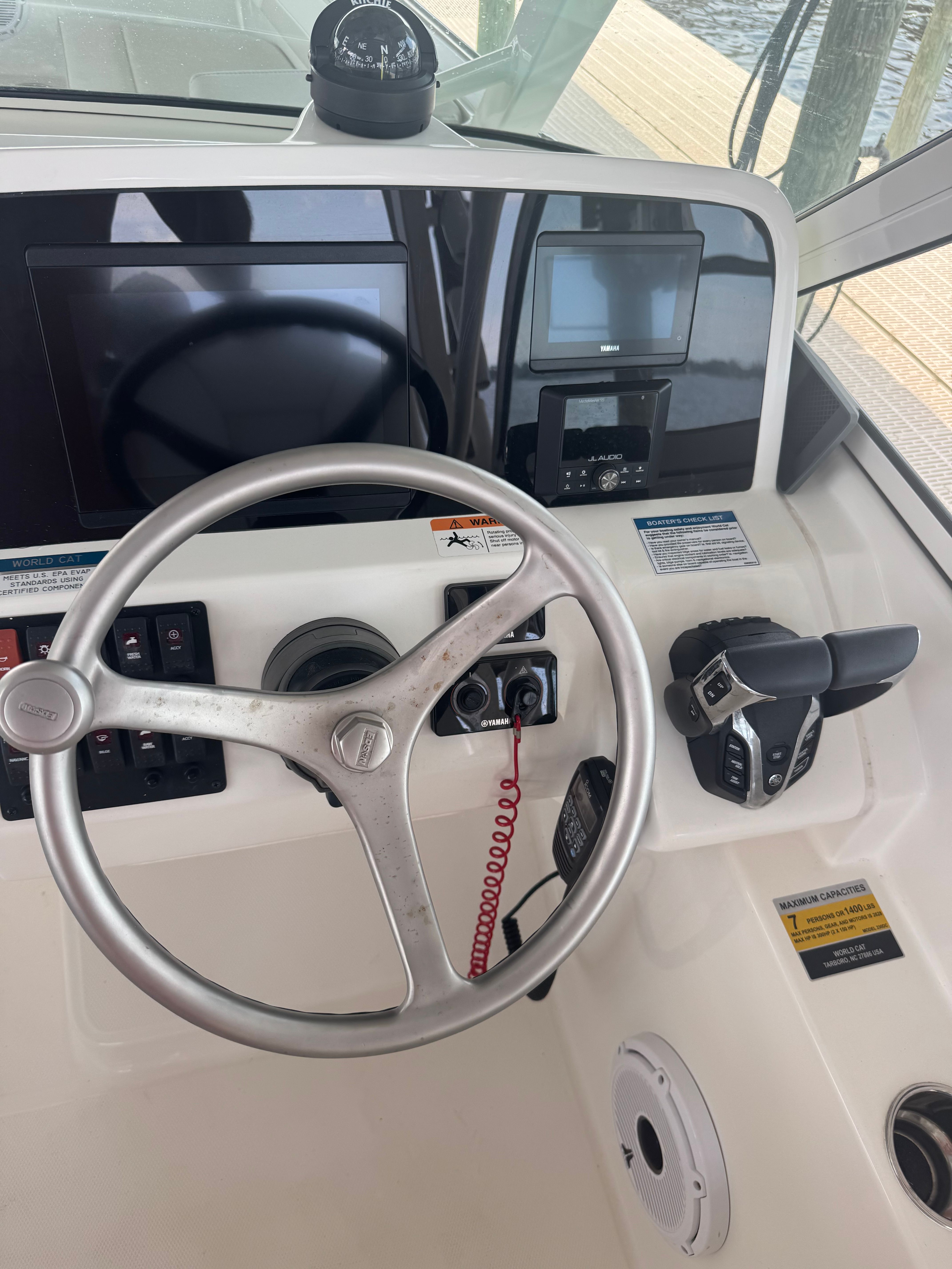 Helm of the World Cat 230 DC with steering wheel and instruments.