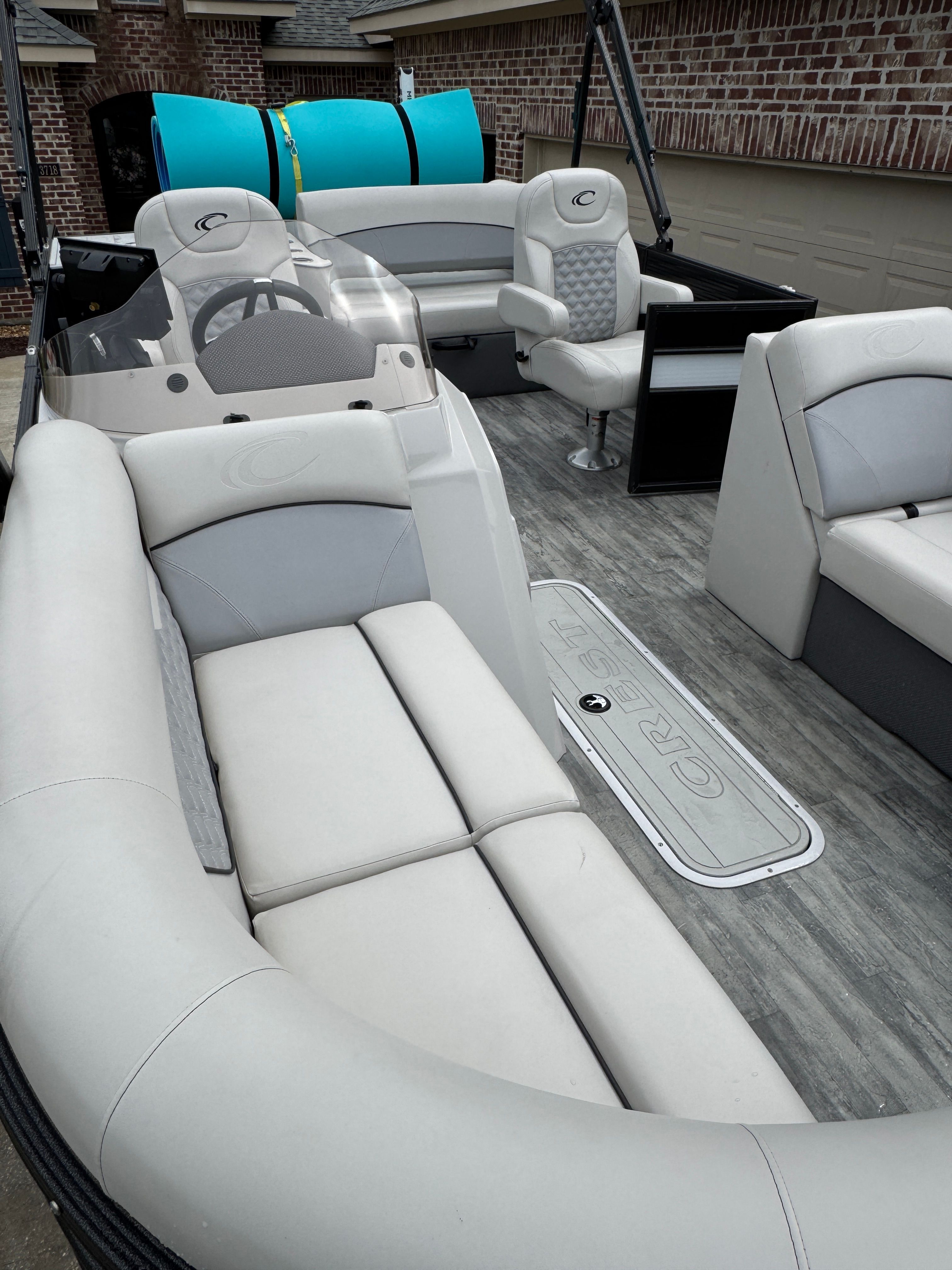 Interior of a 2022 Crest Classic DLX 220 boat with gray seating.
