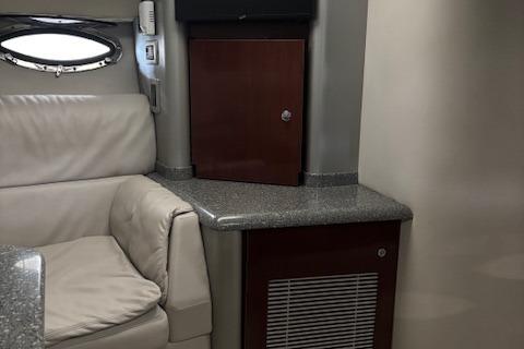 Interior of 2005 Formula 400 SS boat with leather seating and wooden cabinetry.