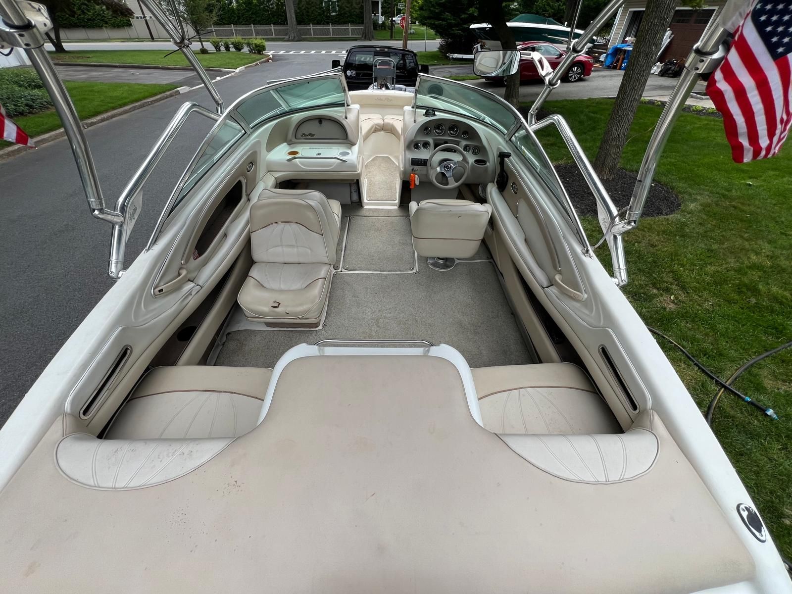 Interior view of a 1997 Sea Ray 190 Bow Rider with beige seats and steering wheel.