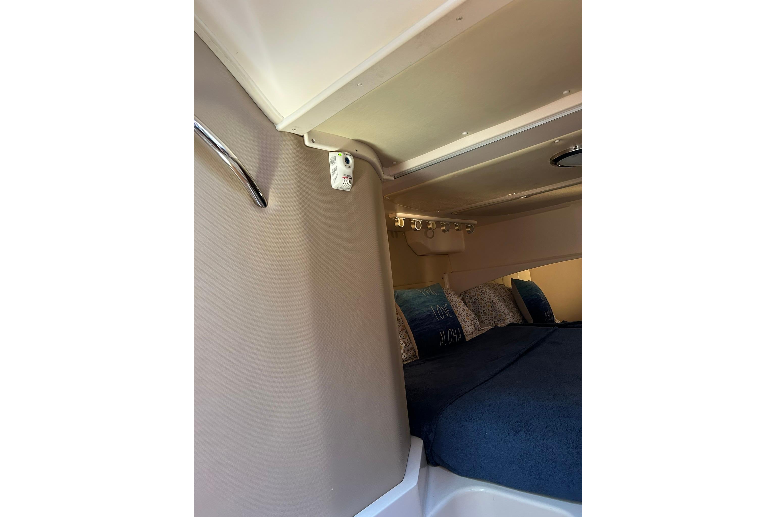 2007 Grady-White Express 360 cabin interior with cozy bedding and ambient lighting.