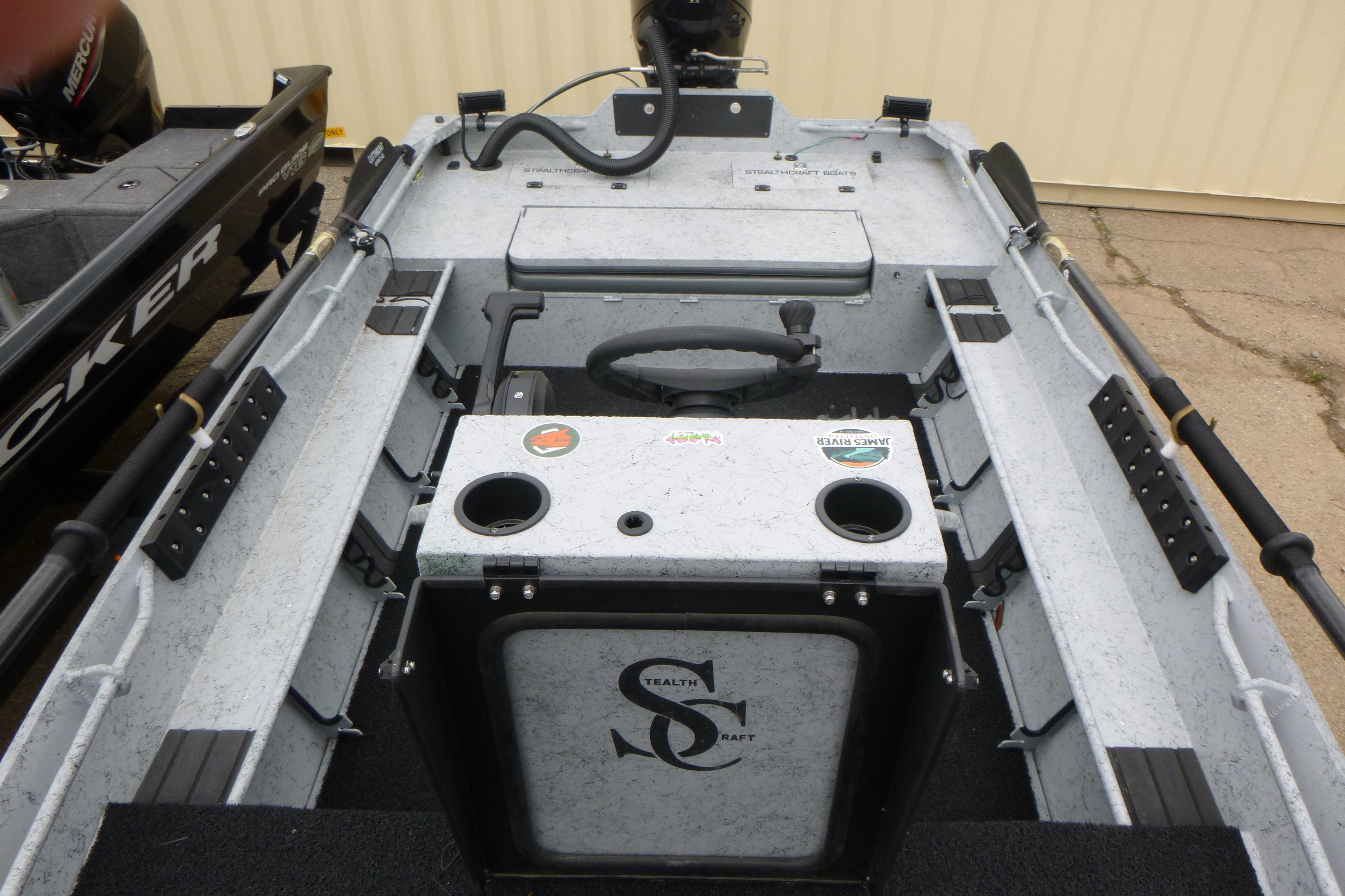 2025 StealthCraft 16 StealthWeld boat interior with steering console and storage compartments.