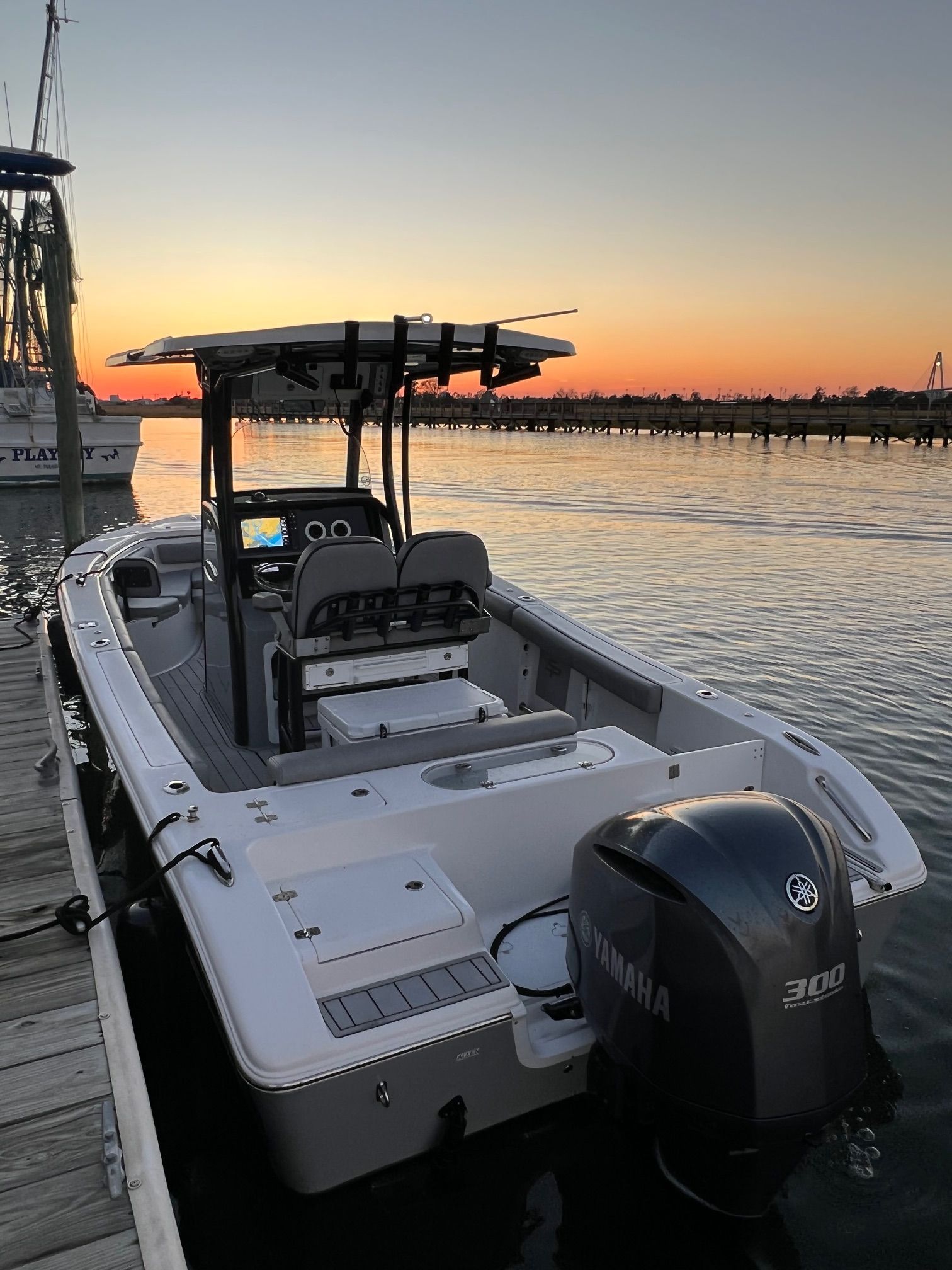 2020 Sea Pro 239 Center Console boat docked at sunset.